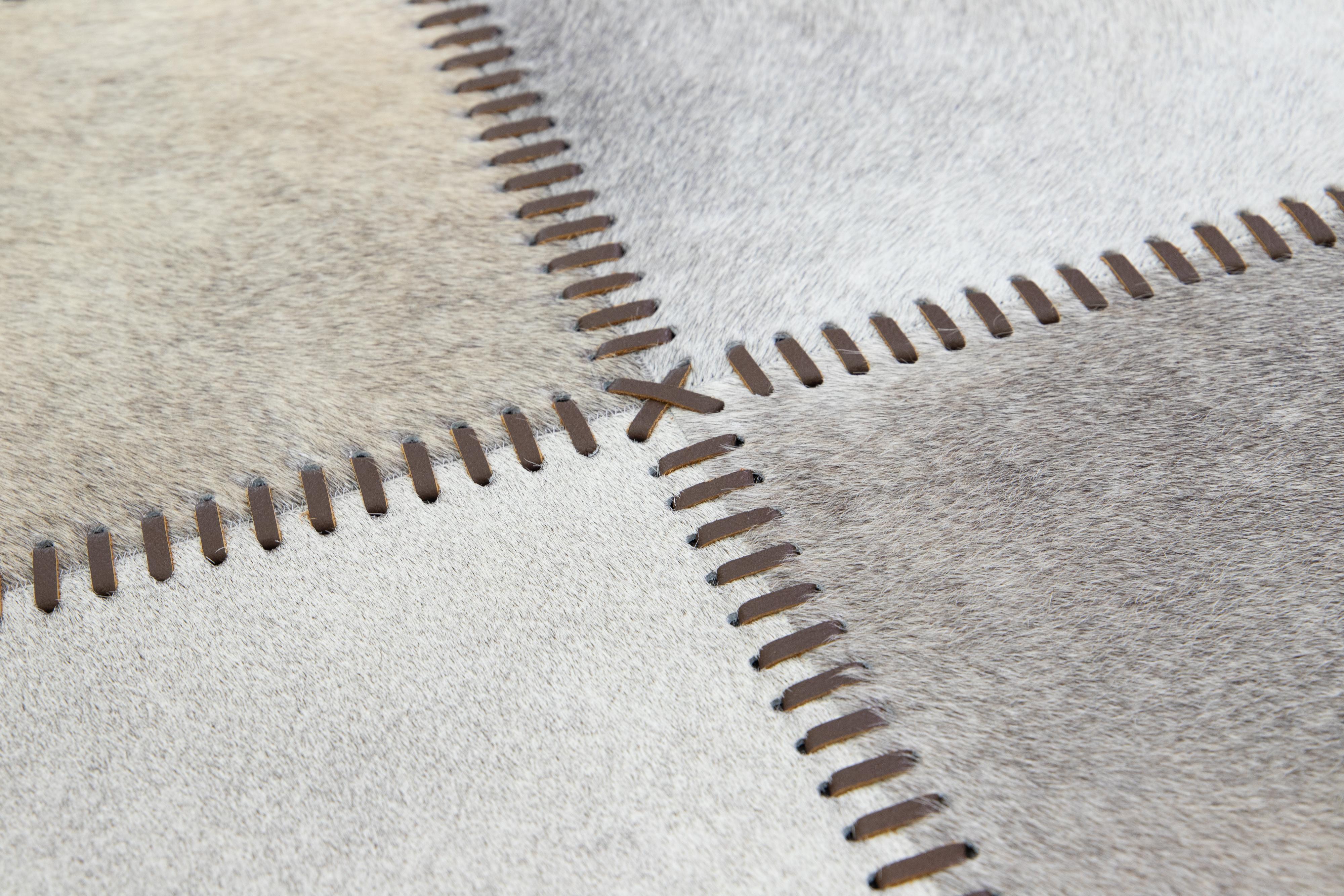The Modern Genuine Cowhide Leather Custom Rug offers customizable options for size and color. It is hand-crafted with Cowhide (Genuine Cowhide Leather) and exudes exceptional quality and durability. Sourced from Argentina, it has a 15-20 week lead