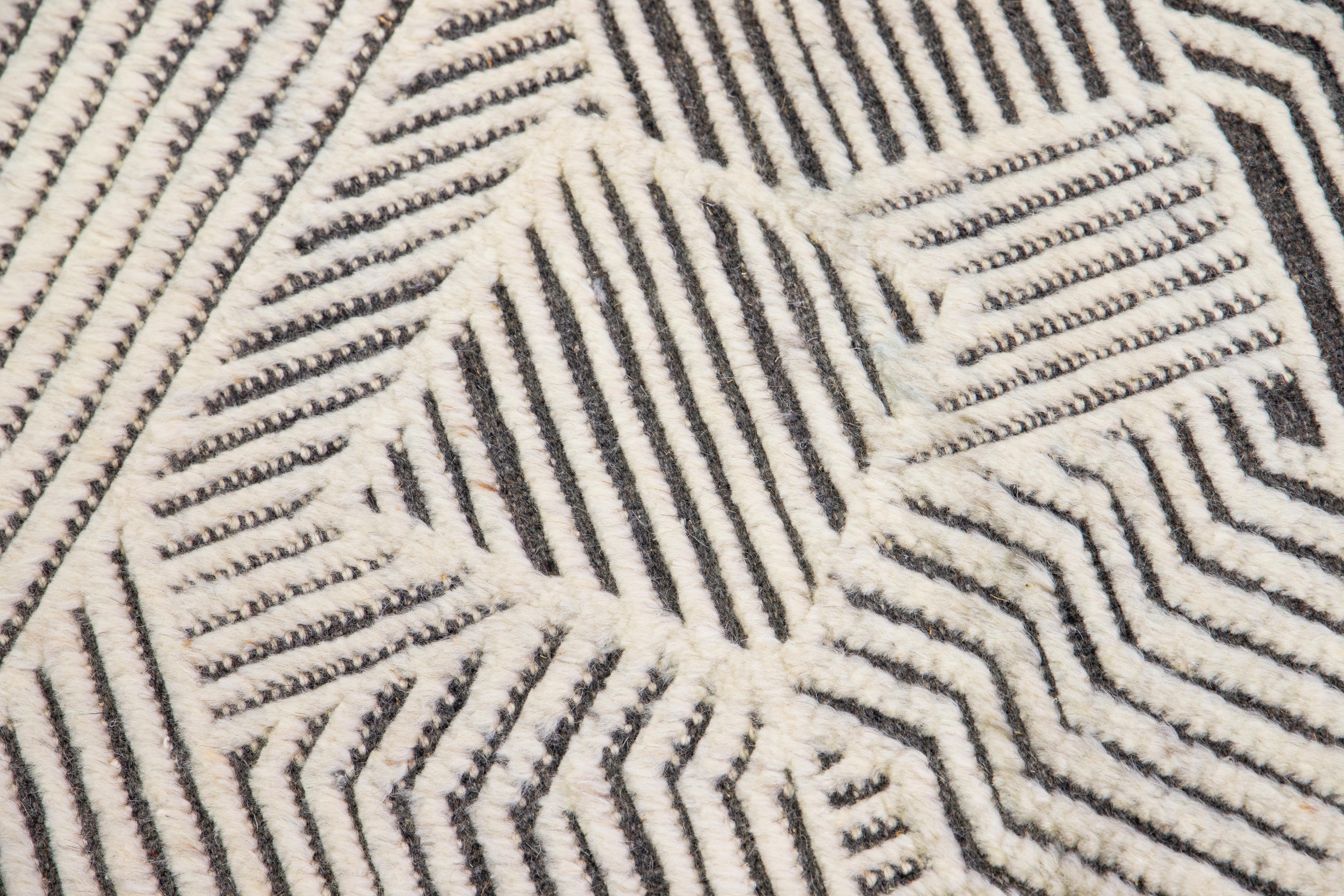 This handcrafted custom wool rug, available in multiple colors, is part of our Safi Collection. We use hand-knotted techniques for superior quality and longevity. 
The estimated lead time for customs is 15-20 weeks.
Material: Wool
Techniques: