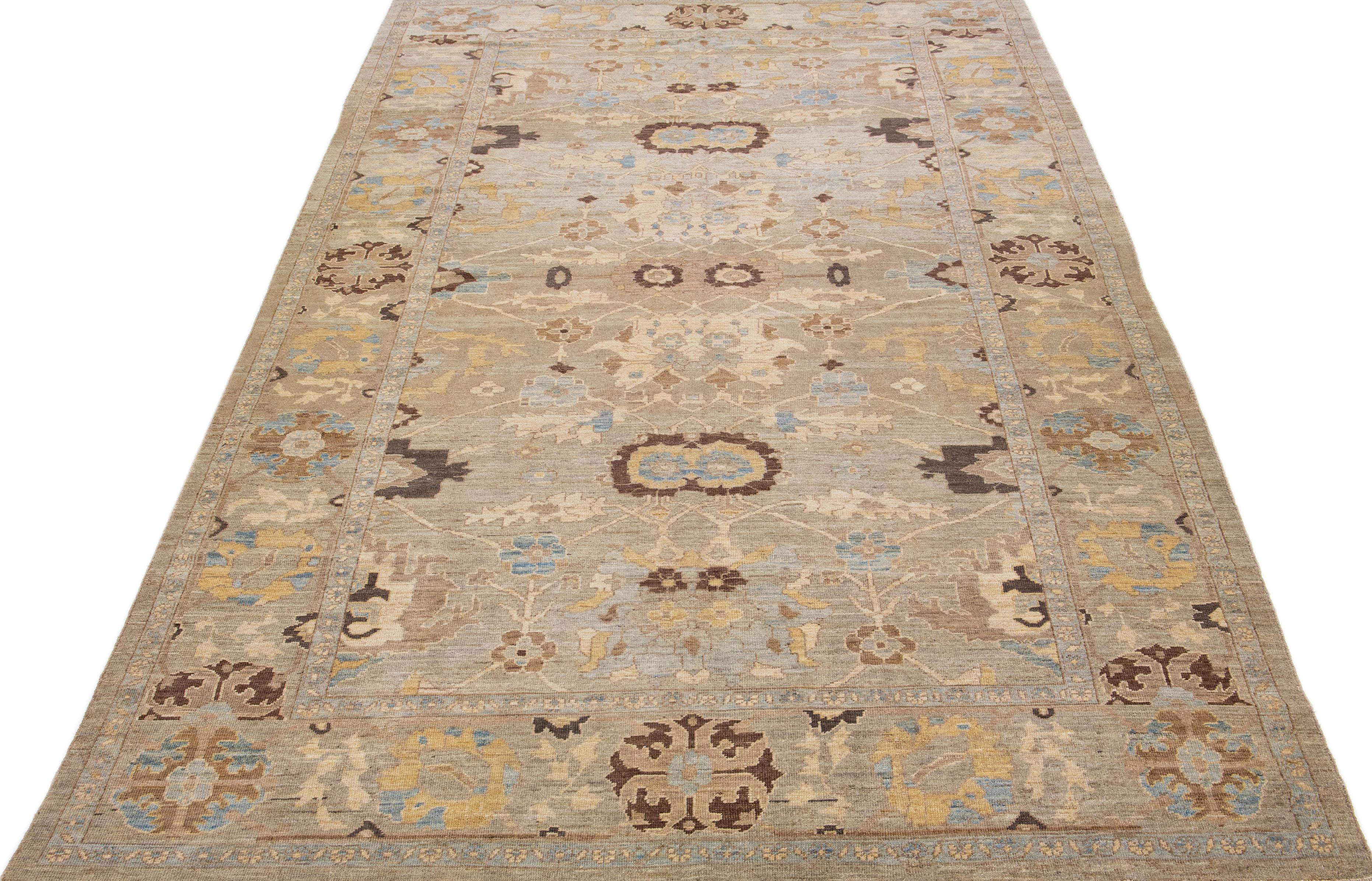 Beautiful Modern Persian Sultanabad hand-knotted wool rug with a brown color field. This Sultanabad rug has accents of beige and blue in an all-over floral design.

This rug measures 8' 8