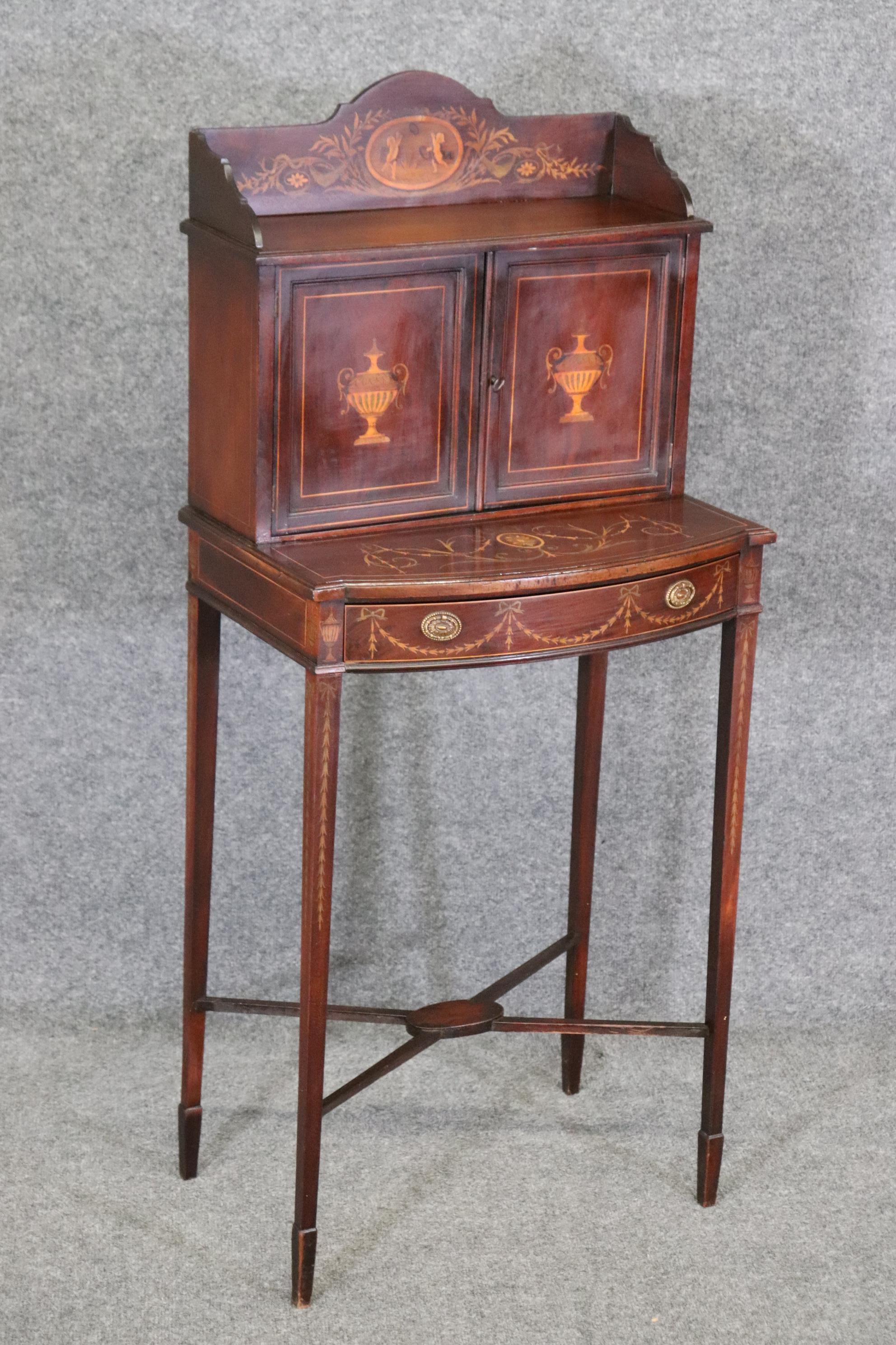 This is a fantastic and small apartment size 1900s era Edwardian secretary. The desk is extremely small, and perfect for a hallway or small space in a tiny area. Think of an apartment in Manhattan, which this would be perfect for. The desk is in its