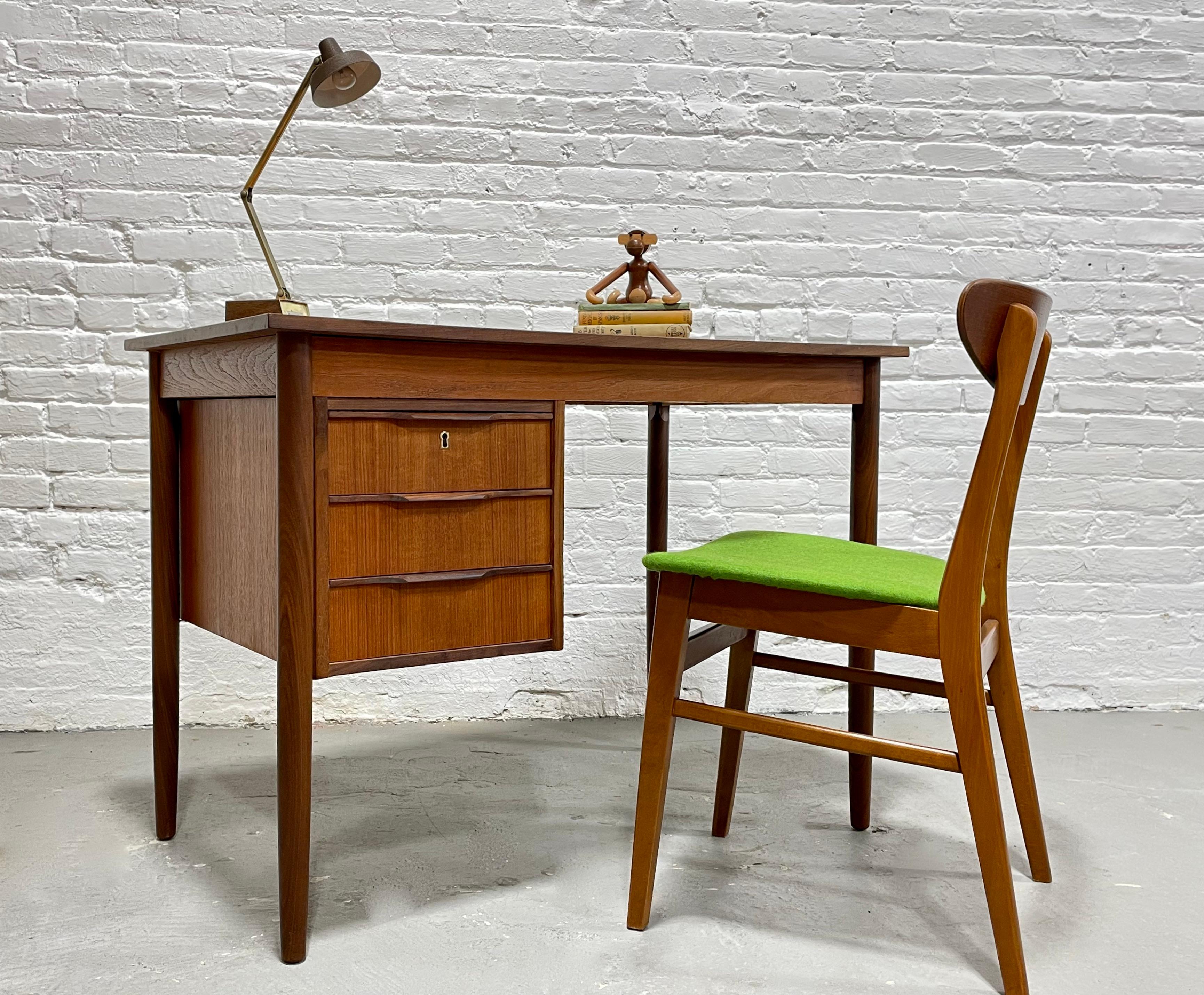 Apartment sized Mid Century Modern Danish Teak Desk by Faarup Mobelfabrik, circa 1960s. Perfectly sized for an apartment or smaller office space yet offers a generous workspace.   Three dovetailed drawers with sculpted hand pulls and a newly