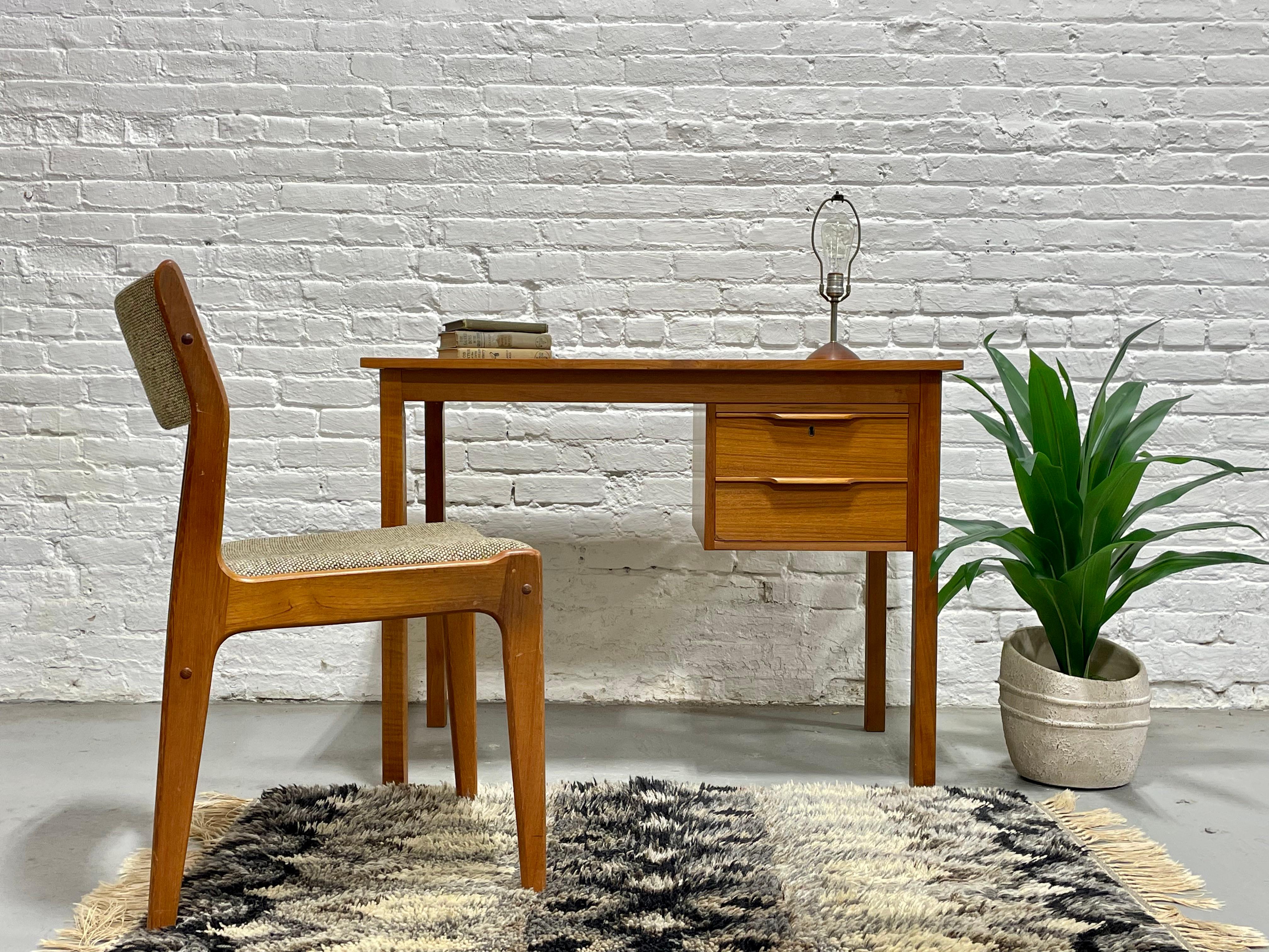 Apartment sized Mid Century Modern Danish Teak Desk by Bent Silberg, circa 1960s. Perfectly sized for an apartment or smaller office space yet offers a generous workspace.  Two drawers with sculpted hand pulls and a newly refinished tabletop with