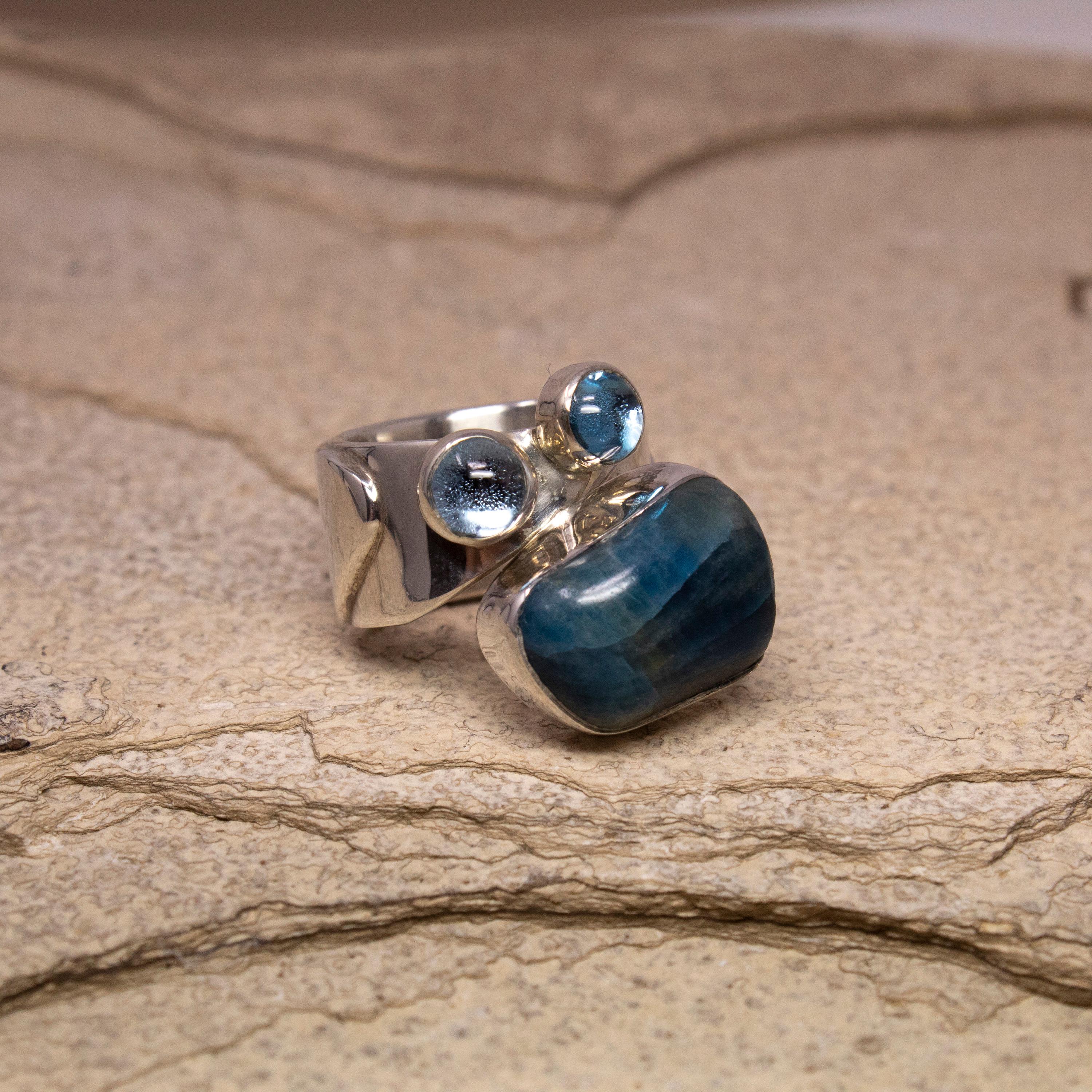 Lilly Barrack's rings have a distinct and instantly recognizable aesthetic. Handmade in New Mexico, these pieces incorporate brightly colored gems into the elegant (and unexpected) sterling silver lines.

-Rough Apatite
-Blue Topaz