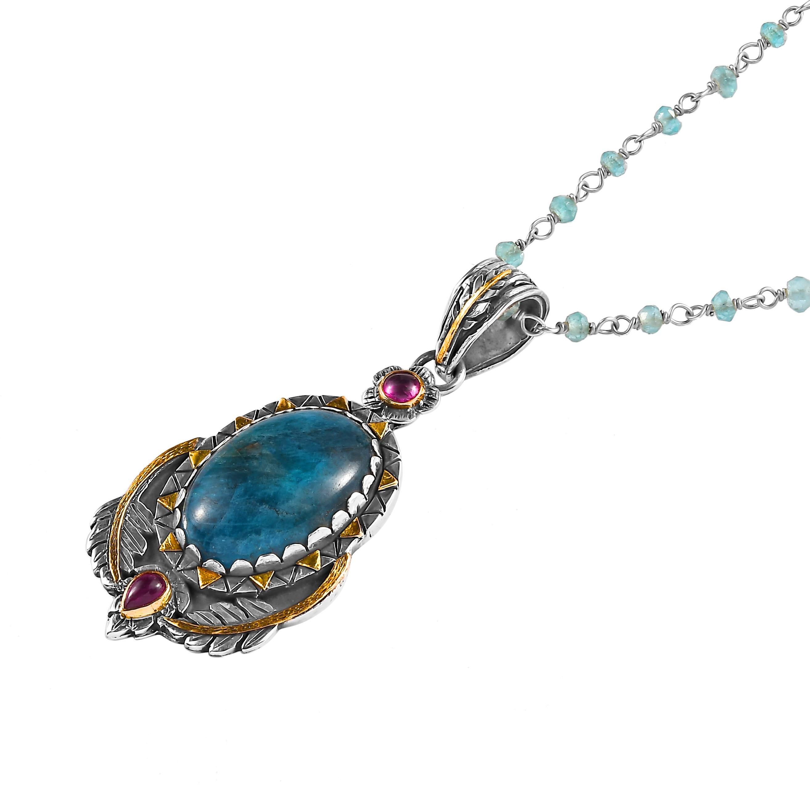 Questo delizioso ciondolo in apatite con rubino, unico nel suo genere, è stato realizzato a mano nei nostri laboratori.

Presenta un grande apatite cabochon affiancato da rubini. Il ciondolo è realizzato in oro giallo 18k e argento sterling