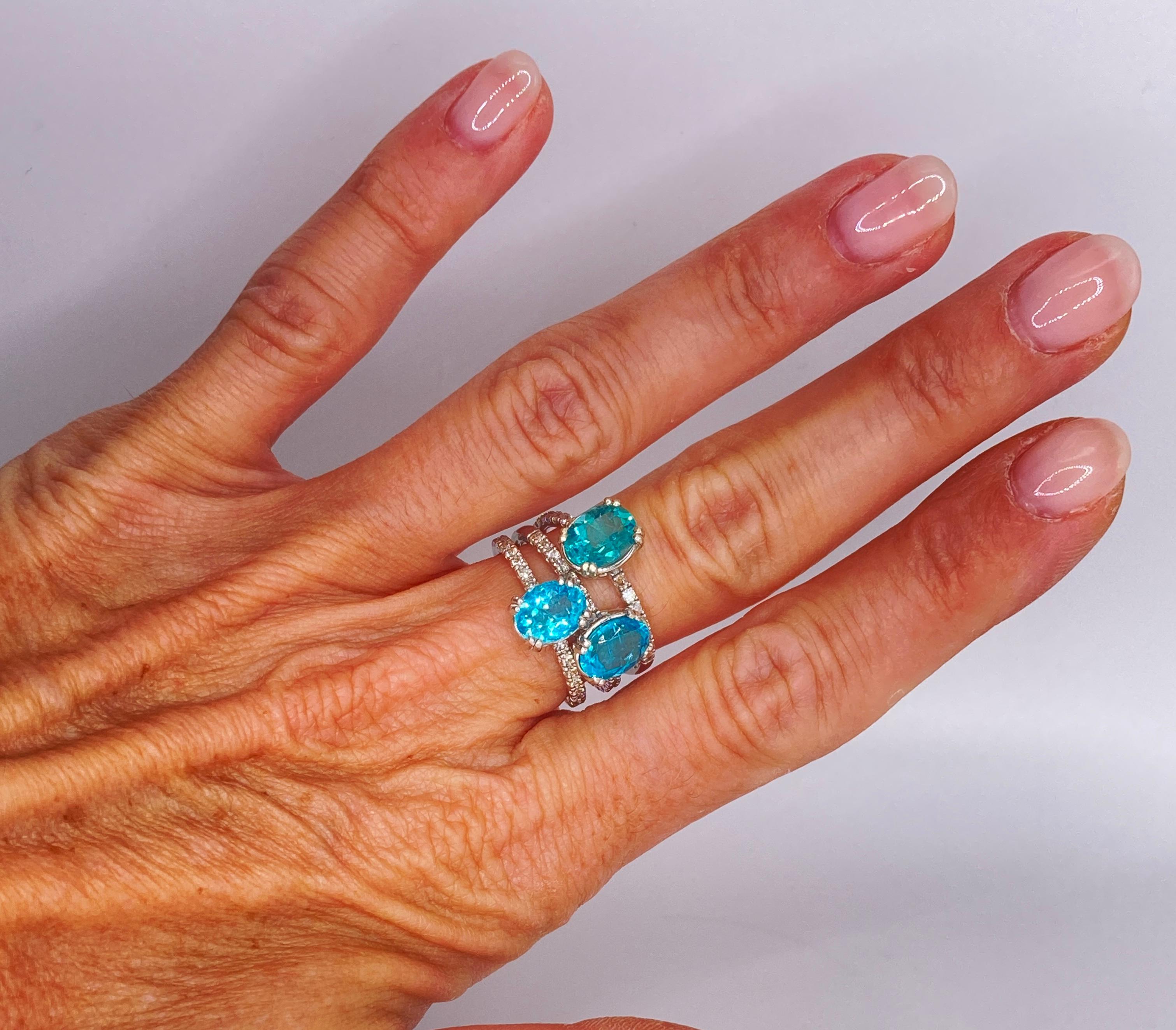 This Three stones Apatite ring is actually three separate Rings stacked together. Set on 14 kt white gold with brilliant cut diamonds.