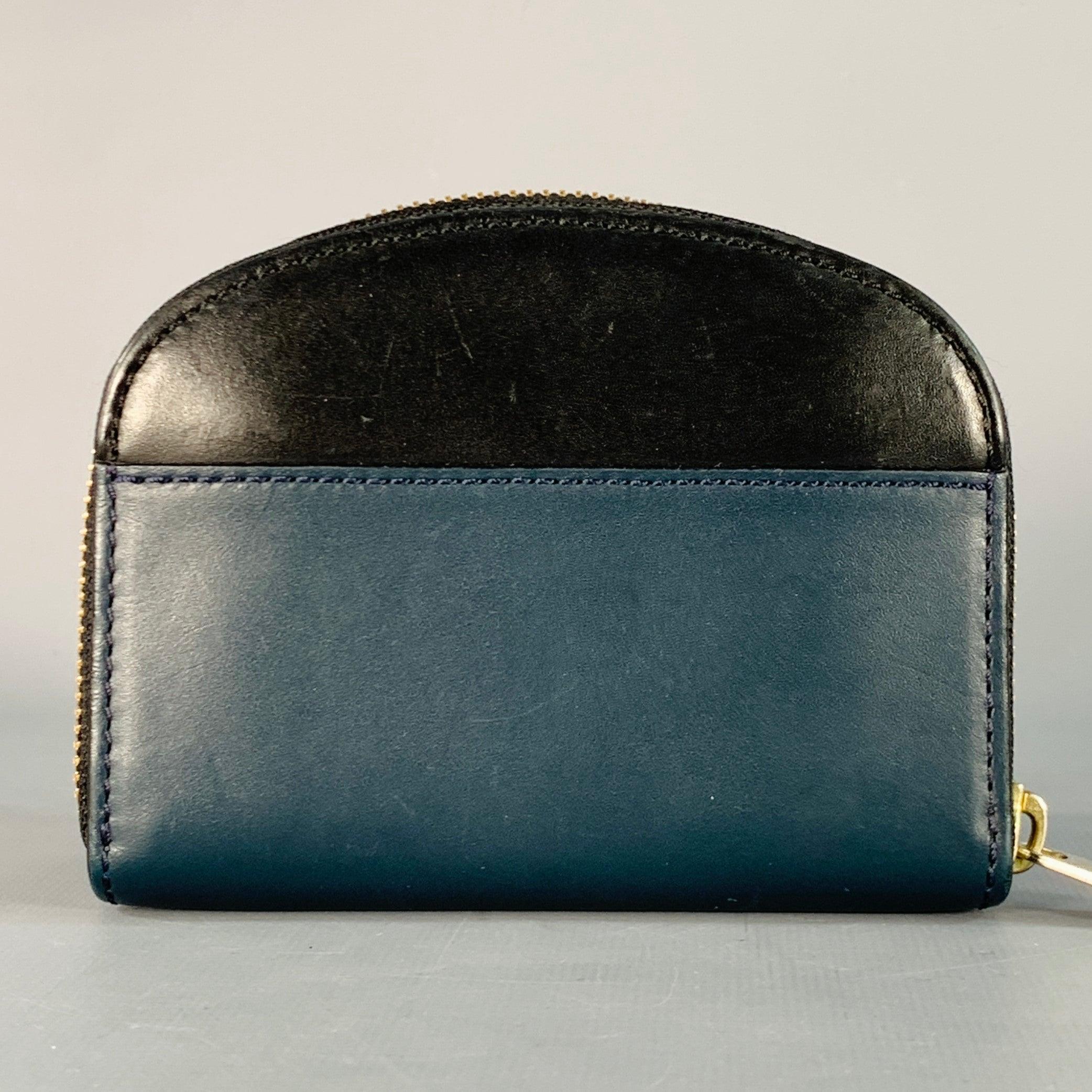 A.P.C. wallet
in a black and blue leather featuring a domed style, multiple interior card slots with zip coin purse, and zip closure.Excellent Pre-Owned Condition.5 x 3.75 inches 
  
  
 
Sui Generis Reference: 140623
Category: Handbag & Leather
