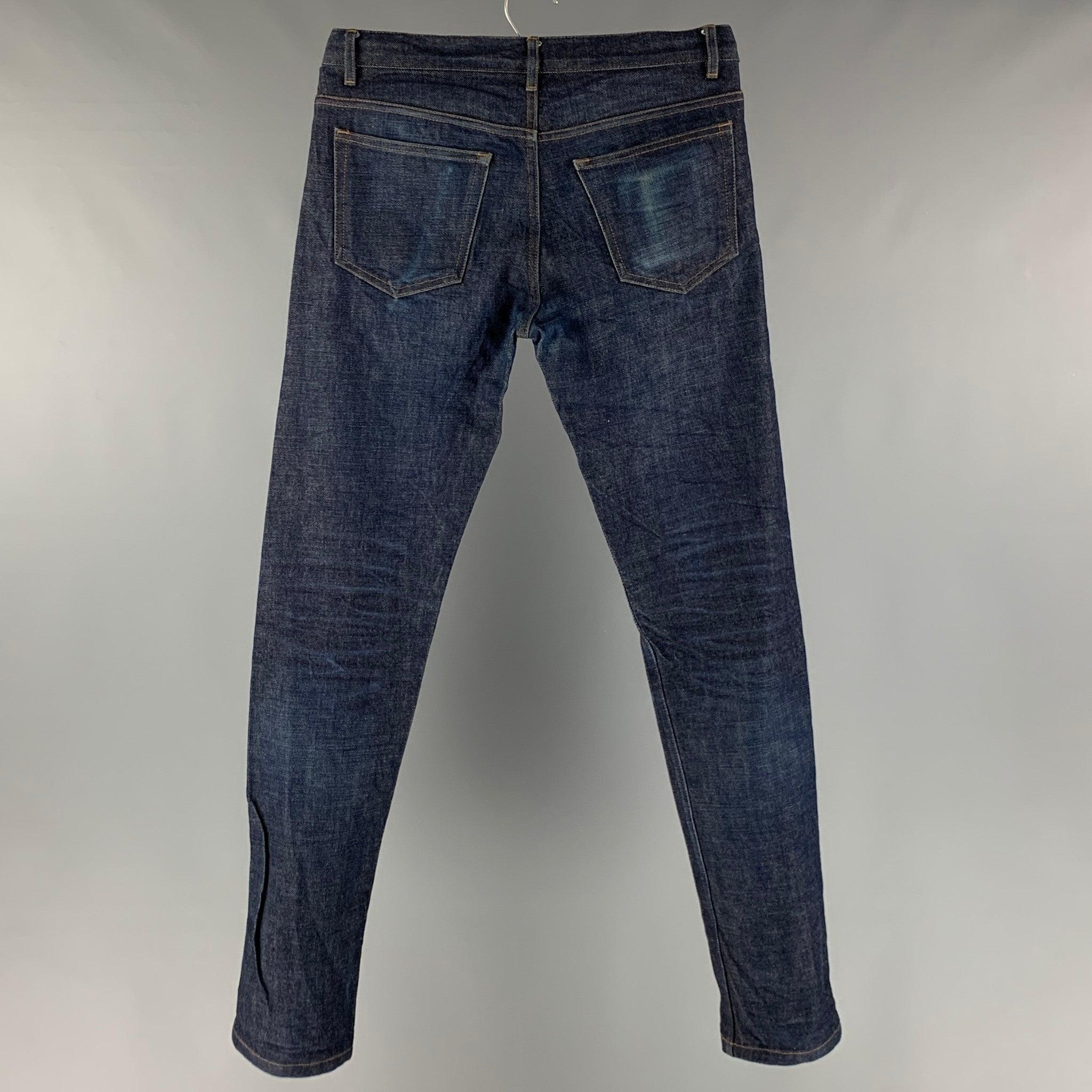 A.P.C jeans comes in a dark blue cotton featuring a straight leg, contrast stitching, and a button fly closure. Very Good Pre-Owned Condition. 

Marked:   29 

Measurements: 
  Waist: 30 inches Rise: 9.5 inches Inseam: 30 inches  
  
  
 
Reference: