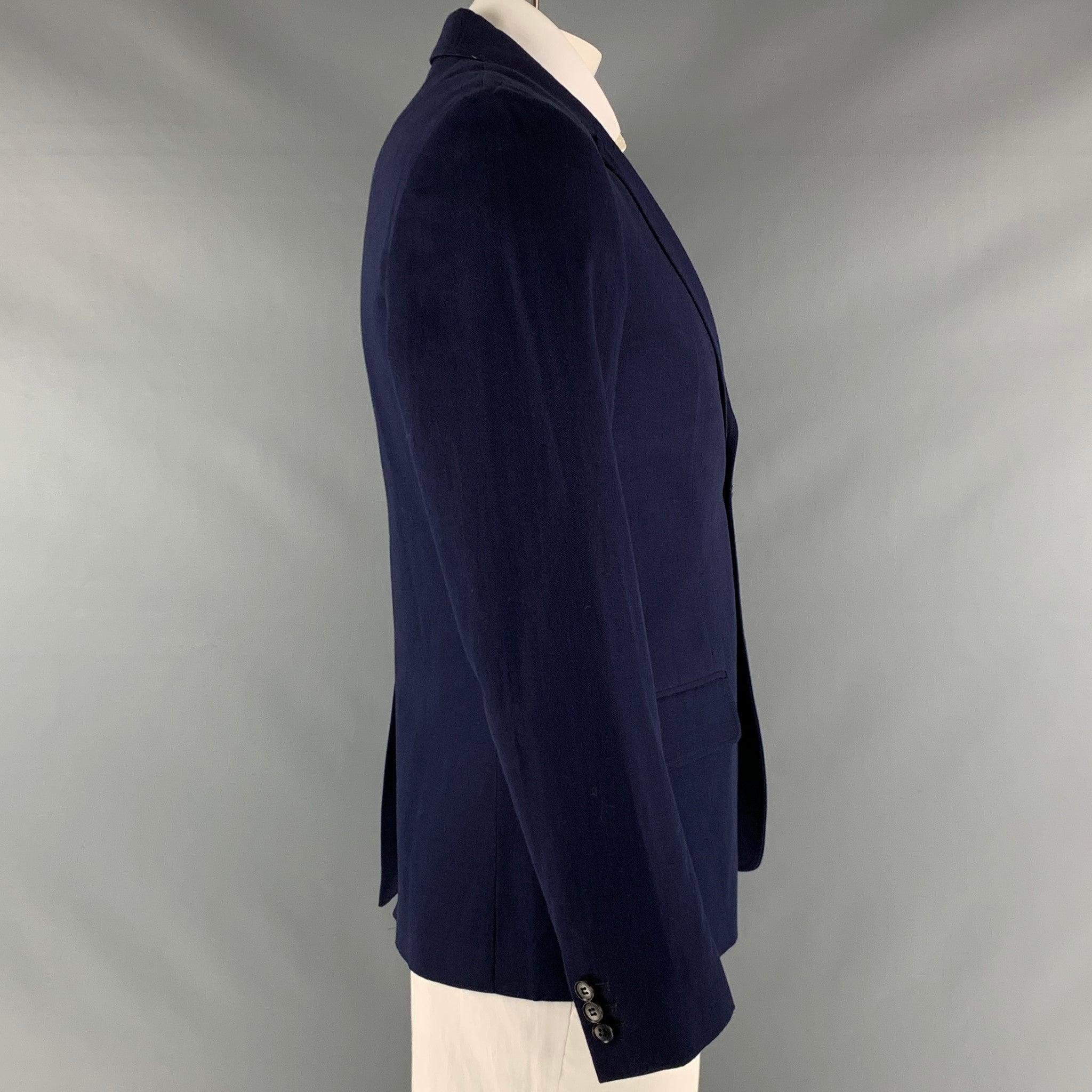 A.P.C. sport coat comes in a solid navy cotton and linen twill material and a full liner, with a notch lapel, flap pockets, a double button closure, single breasted,
 and single back vent.Excellent Pre- Owned Condition. 

Marked:  
L 

Measurements: