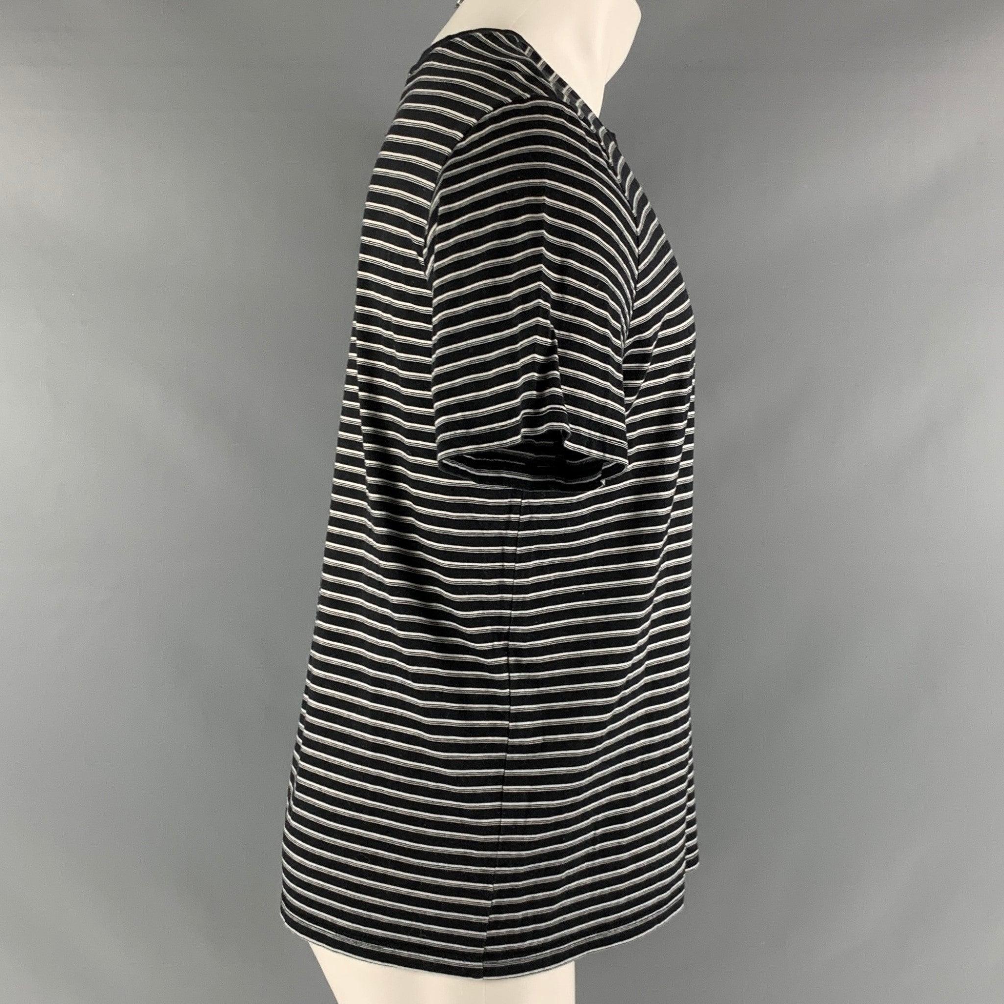 A.P.C. T-shirt comes in black and white cotton jersey knit and features a crew- neck.Very Good Pre-Owned Condition. Minor signs of wear. 

Marked:   M 

Measurements: 
 
Shoulder: 18 inches Chest: 38 inches Sleeve: 8 inches Length: 25 inches  
  
 
