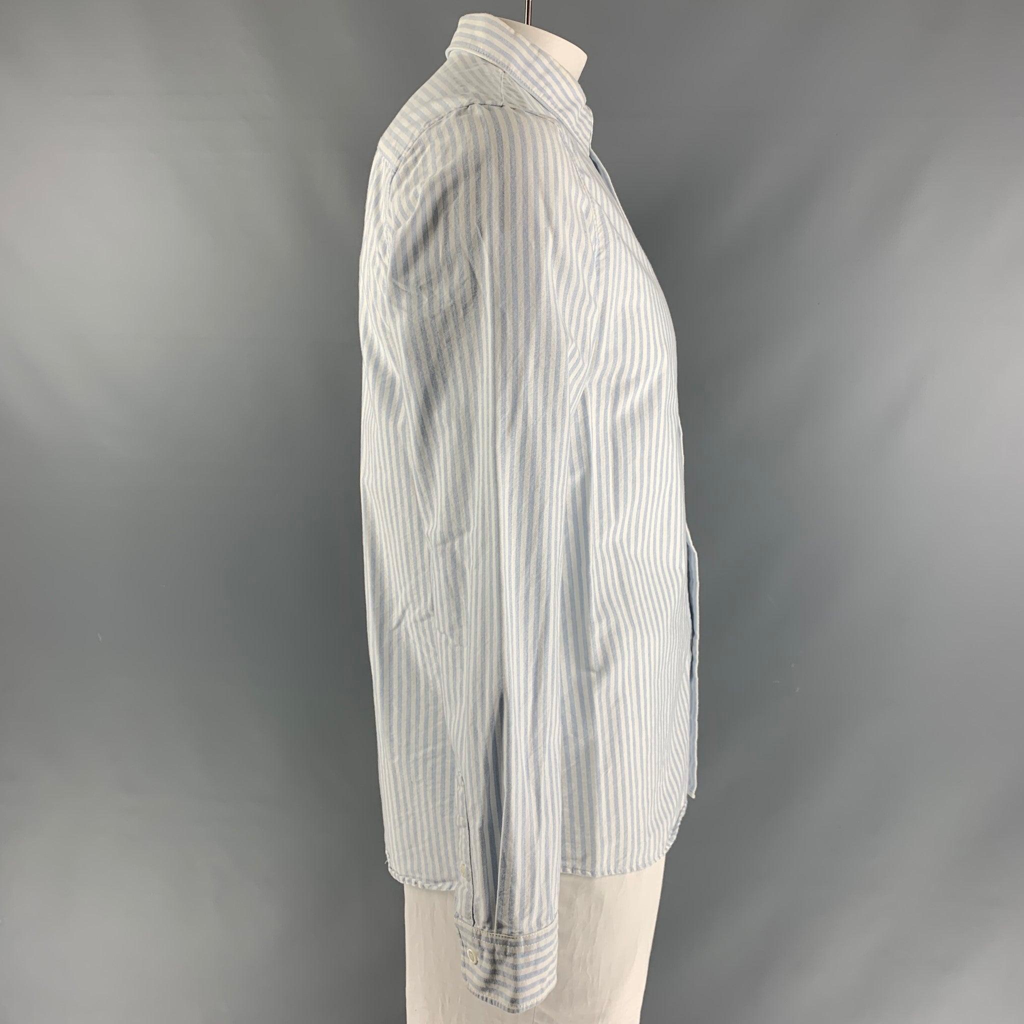 A.P.C. long sleeve shirt comes in blue and white stripped cotton featuring straight collar, button up closure and frontal pocket.Very Good Pre-Owned Condition. Minor discoloration at inside collar. 

Marked:   XL 

Measurements: 
 
Shoulder: 18