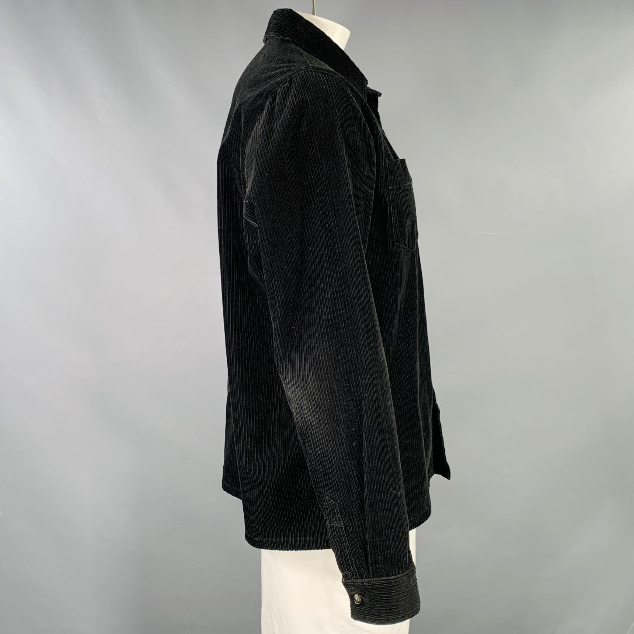 A.P.C. long sleeve shirt
in a black cotton corduroy featuring two pockets, and button closure. Good Pre-Owned Condition. Moderate signs of wear, particularly on elbows. 

Marked:   XXL 

Measurements: 
 
Shoulder: 18 inches Chest: 48 inches Sleeve: