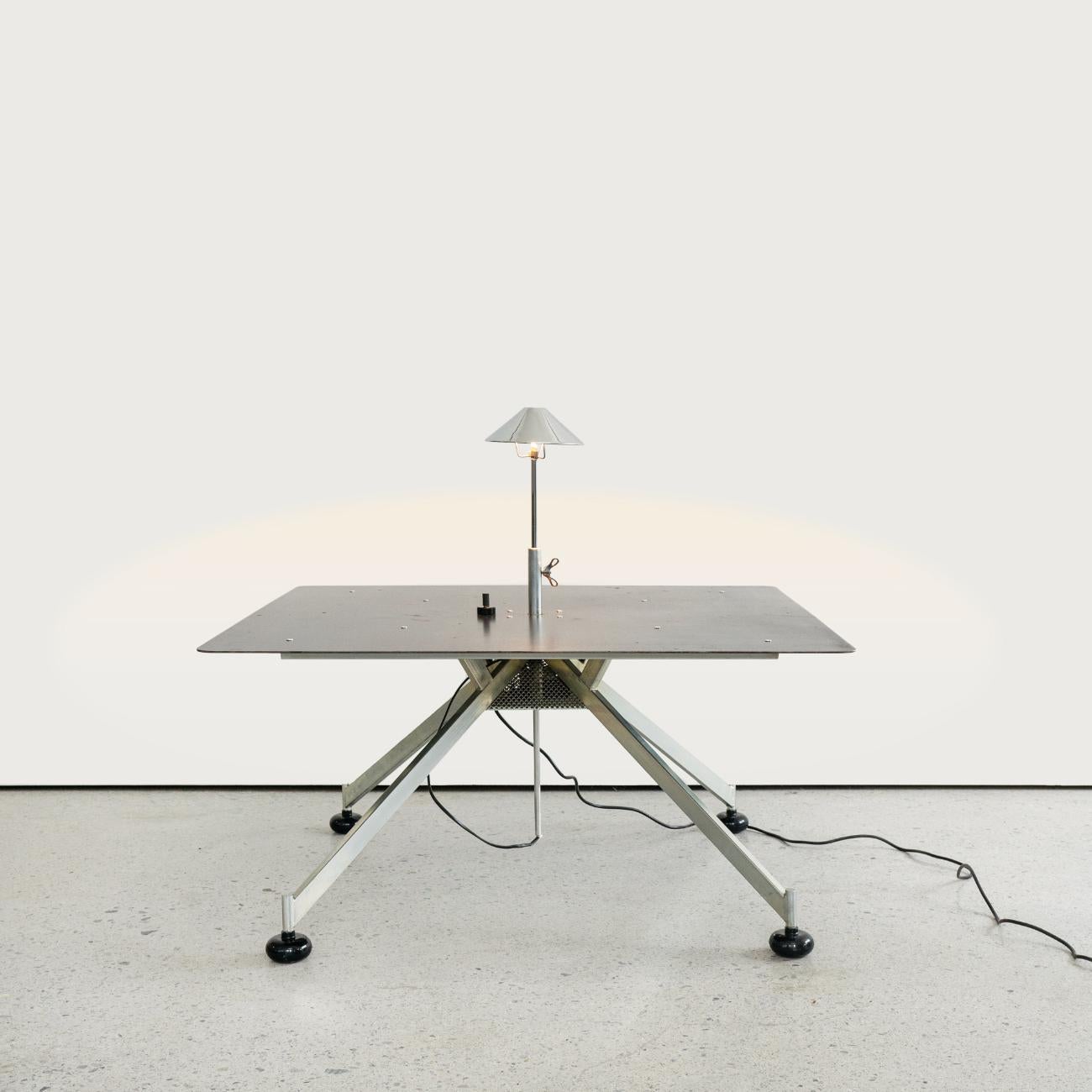 Italian Mid-Century Modern Apocalisse now coffee table by Carlo Forcolini, 1980s.
Apocalisse now square coffee table in iron with legs in pyramid structure. In the center of the piano is the lamp, the height and intensity of the light of the lamp