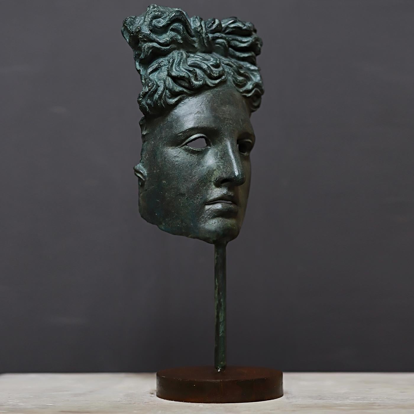 A superb addition to a personal collection or a magnificent gift for a lover of antiquity, this mask reproduces in stunning detail the iconography of the Greek god Apollo, as seen in the post-Hellenist marble statue displayed at the Cortile