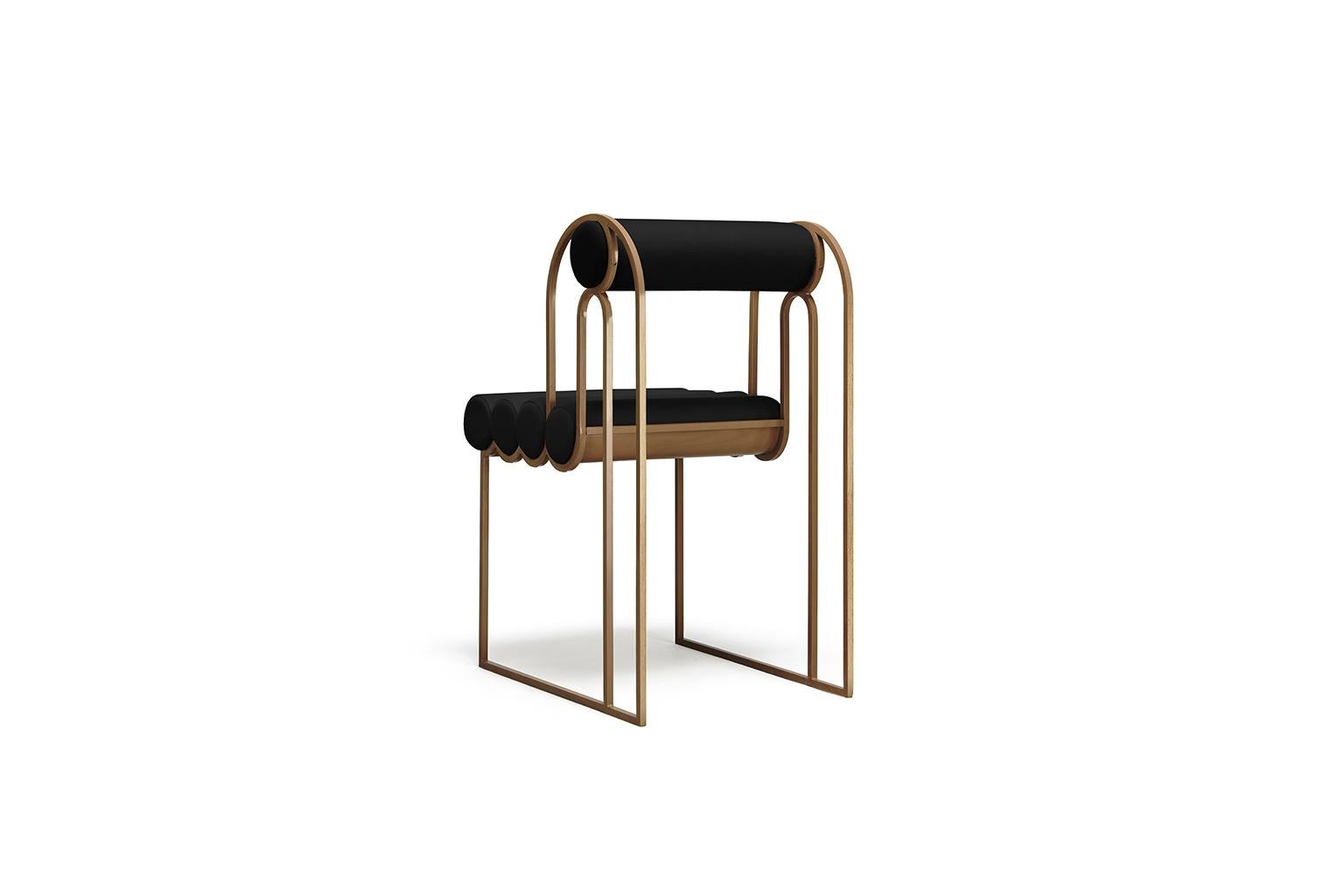 Apollo dining chair - Black and bronze by Bohinc Studio. This chair creates a graceful appearance in a flowing mix of brass and black fabric. The metal loops continue with the wavy seat which is made with wool. The brass loops are configured to