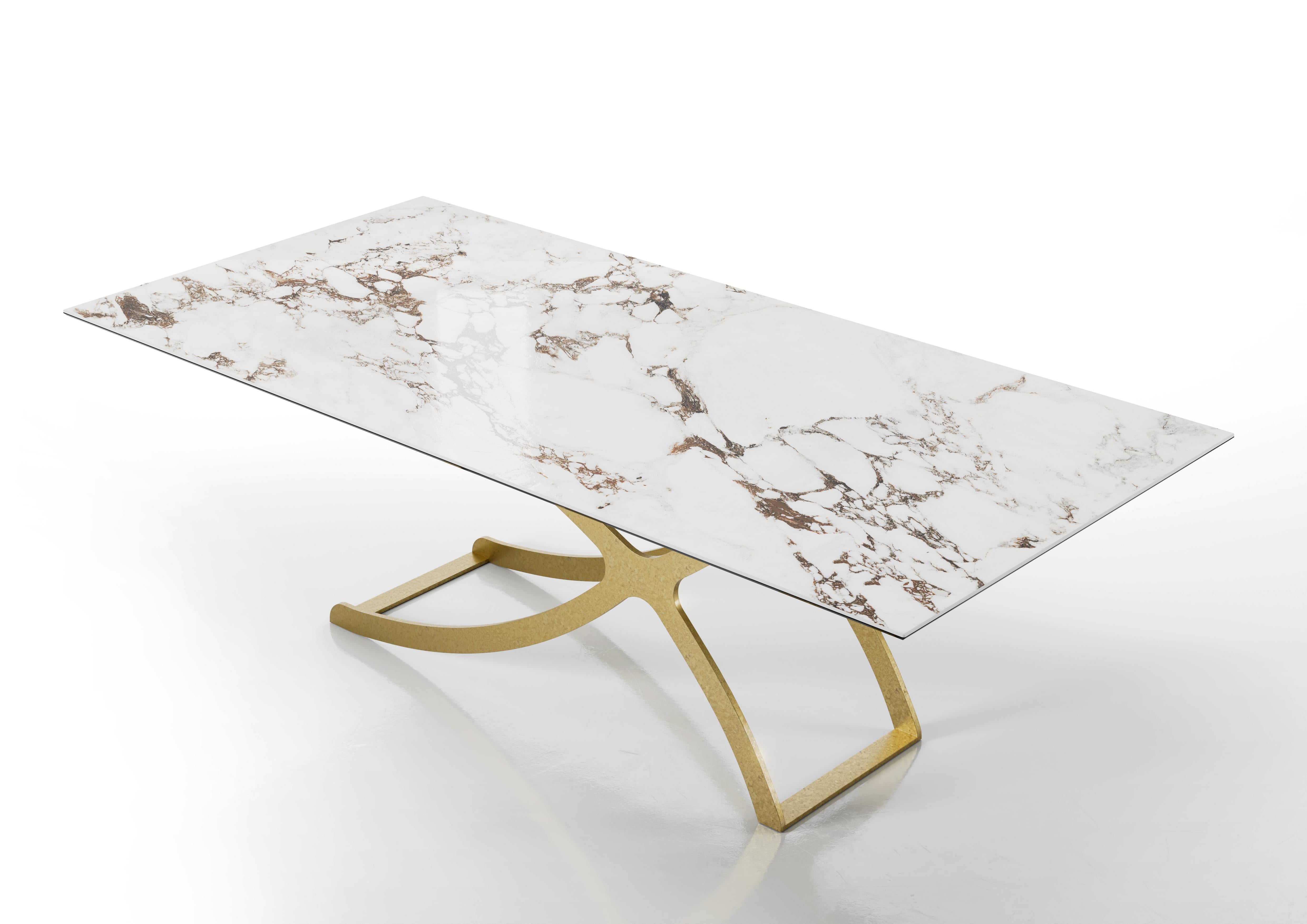 Apollo Dining Table by Chinellato Design
Dimensions: W 250 x D 120 x H 72 cm
Materials: 
Top: Glossy Capraia ceramic top with an extra clear smooth tempered glass under-top.
Base: Chabin gold-finished.


The base, crafted from worked and welded