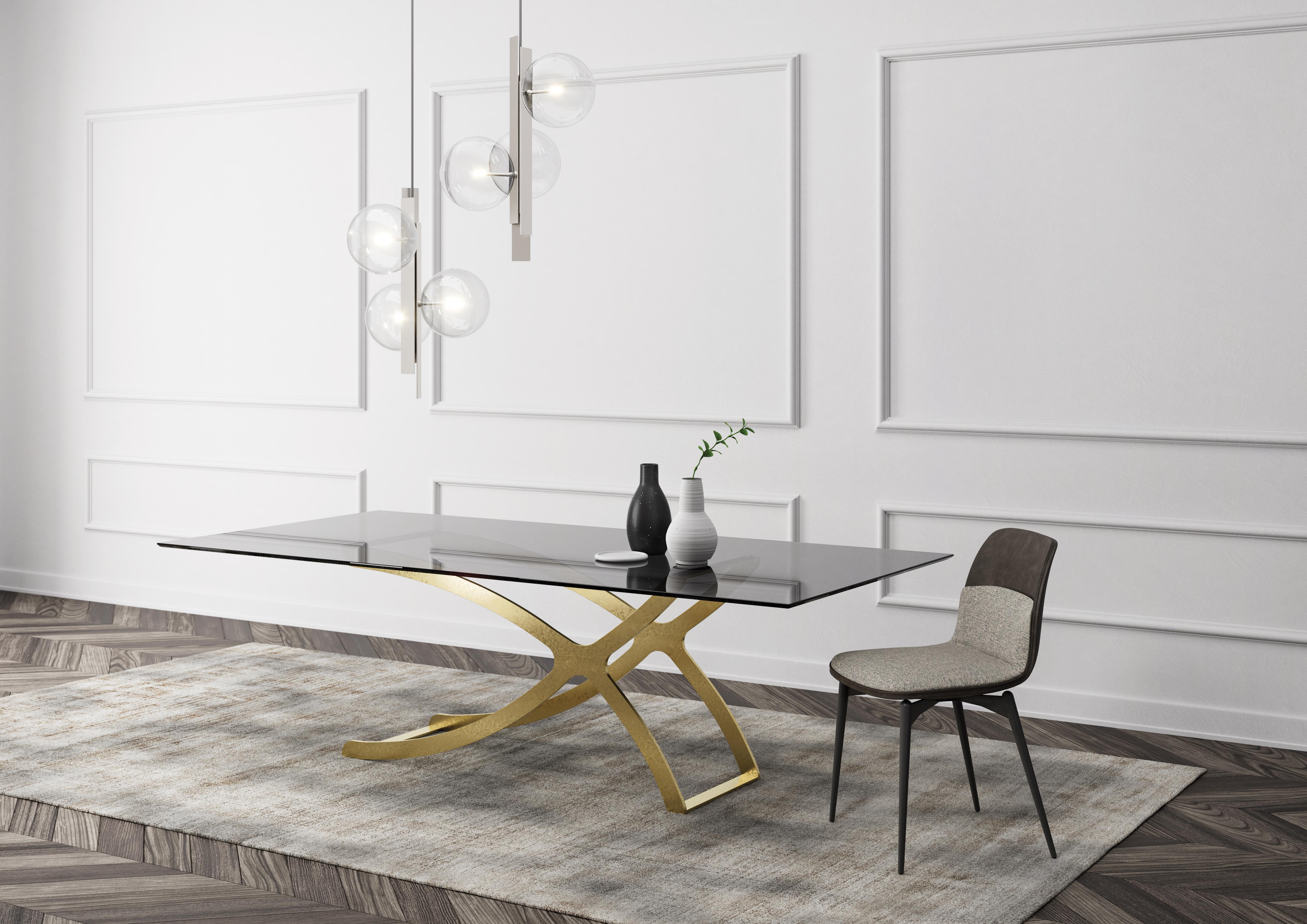 Apollo Dining Table by Chinellato Design
Dimensions: W 250 x D 120 x H 72 cm
Materials: Top: Smooth smoked tempered glass
Base: Chabin gold-finished.


The base, crafted from worked and welded steel, is available in Chabin Gold or Matte Black Paint