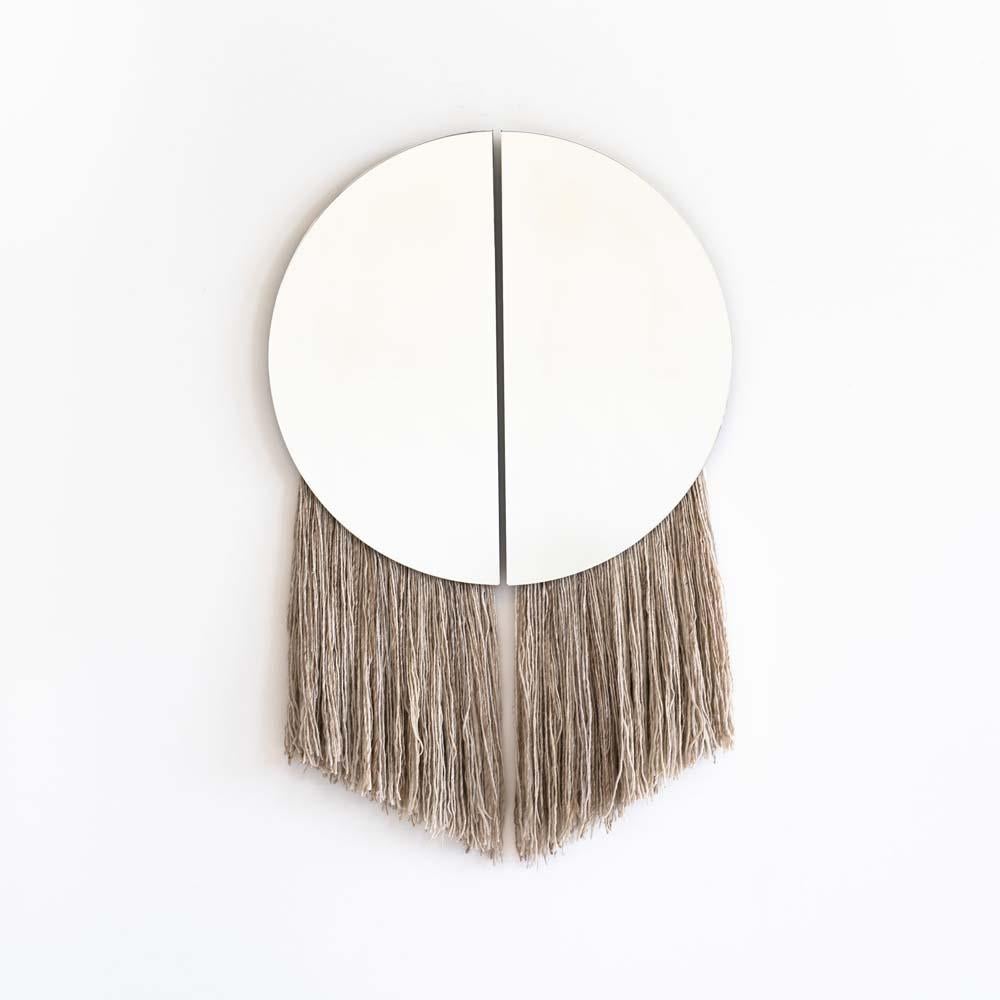 A silk fiber wall mirror in tribute to Apollo
Named for the Greek God of the Sun, the Apollo Mirror is the marriage of sculptural and functional object, with two half circle mirrors joined by negative space and partnered with hand-spun,