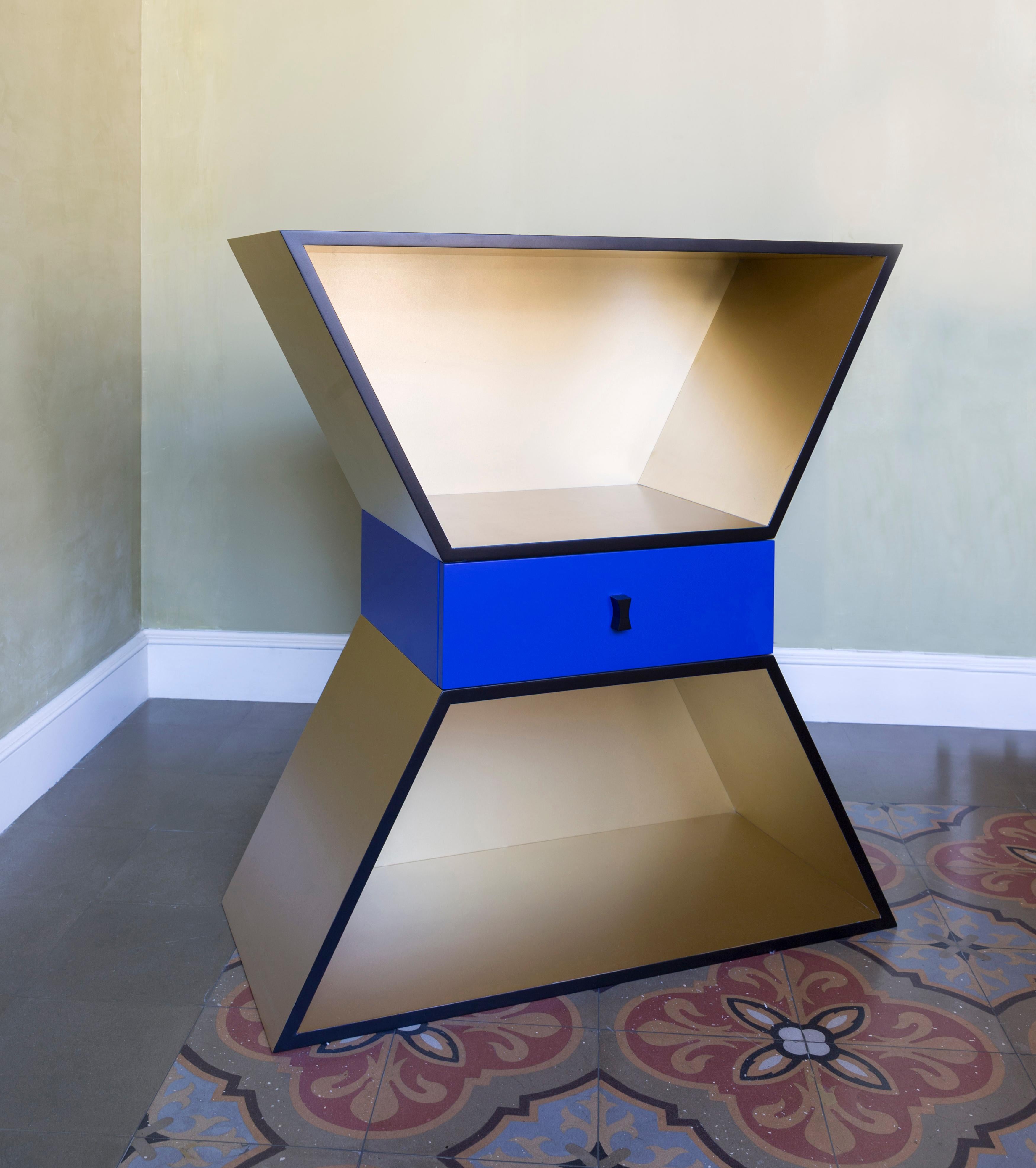 Apollon is a sculptural storage cabinet designed from an hourglass shape. The chromatic balance of this piece of furniture with an Art Deco style is contrasted by the central drawer to create a new harmony of colors.

Apollon is a sculptural storage