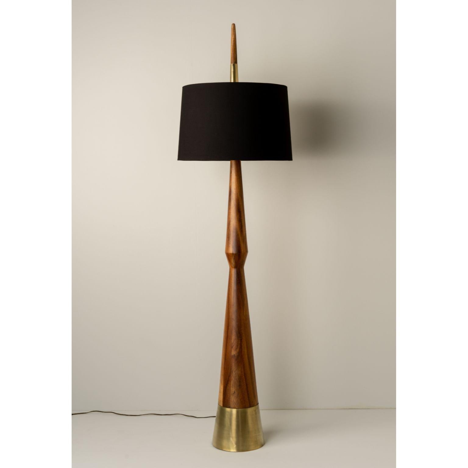 Apolo Floor Lamp by Isabel Moncada
Dimensions: Ø 56 x H 211 cm.
Materials: Fiberglass, linen, gold lacquer and natural matte Parota wood.

The obelisk is named after the famous Greek deity that holds a bow and arrow. The tip of this lamp points