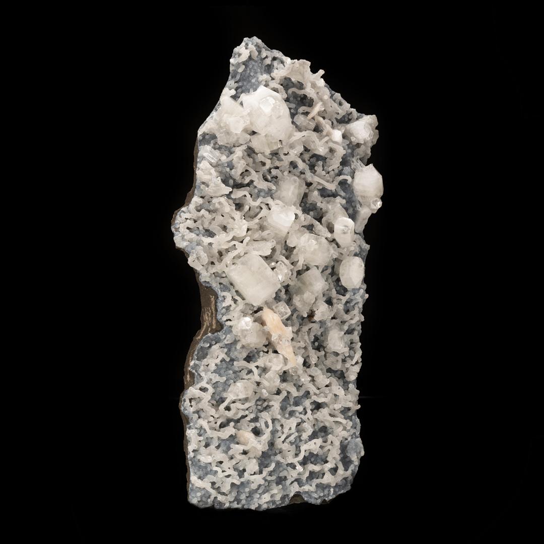 This textural, sculptural combination piece out of Puna, India features lustrous, large, beautifully formed gemmy crystals of apophyllite growing three dimensionally with deeply pigmented peach-hued stilbite – including a  sizable double-terminated