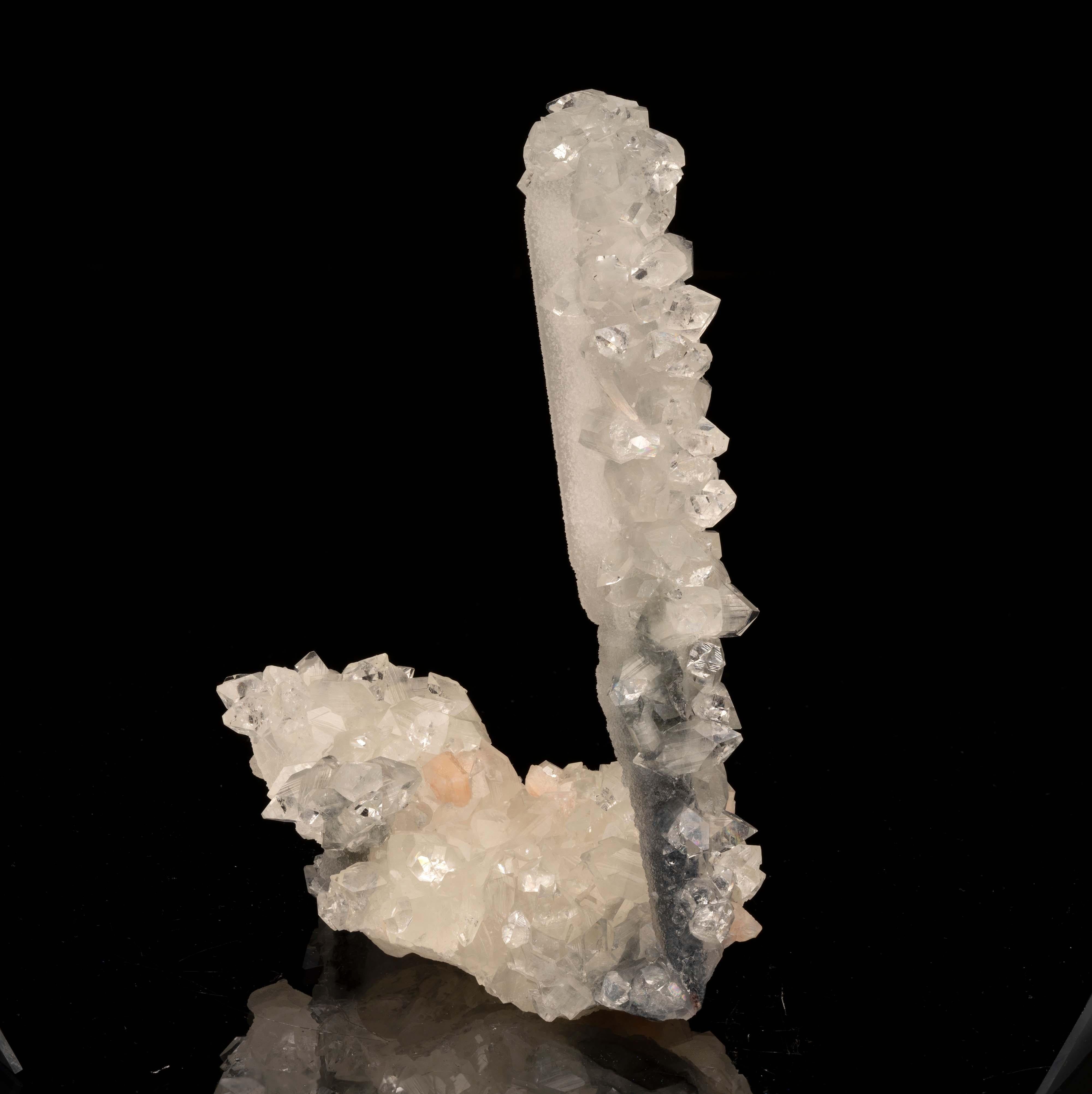 <p>An agate stalactite with druzy calcite, a pseudomorph of apophyllites, and a small accenting stilbite. The long dark agate growth beautifully transitions from calcite to apophyllites. A classic 