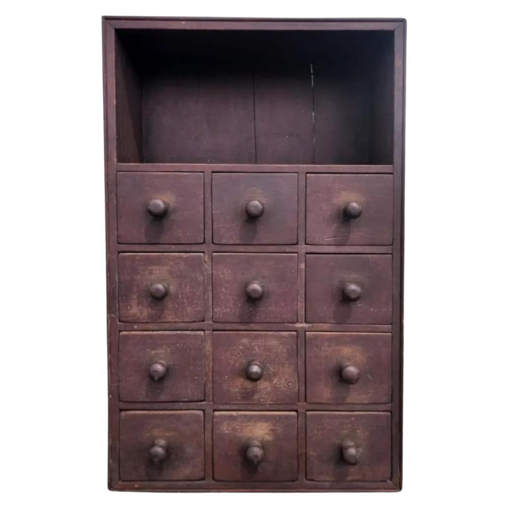 This artists pigment cabinet is on an amazing state of preservation. This circa 1800-1820, chest was designed for holding a artists supplies for mixing paints. Each drawer containing remnants of the individual colors as pictured. The upper shelf