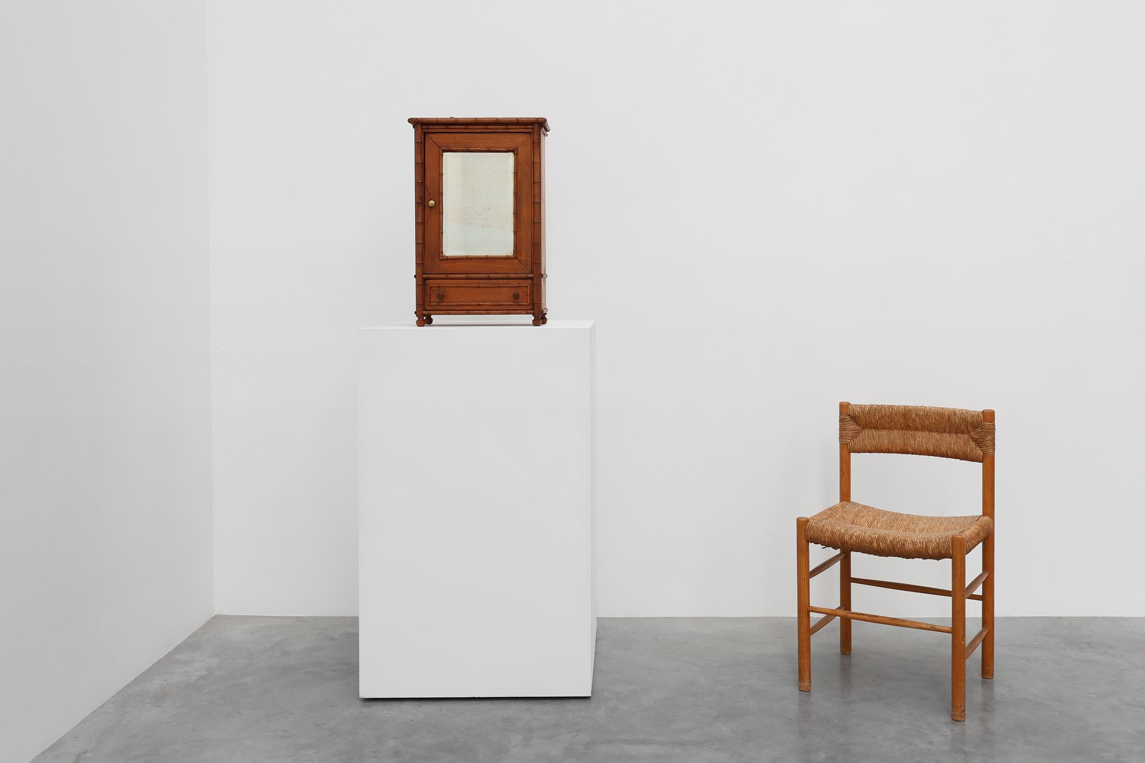 France / 1900 / cabinet / wood / mirror / Rustic / Mid-century 

A beautiful elegant small wall mounted cabinet in wood and faux bamboo. This shaving cabinet features a door with its original characterful beveled weathered mirror, two shelves behind