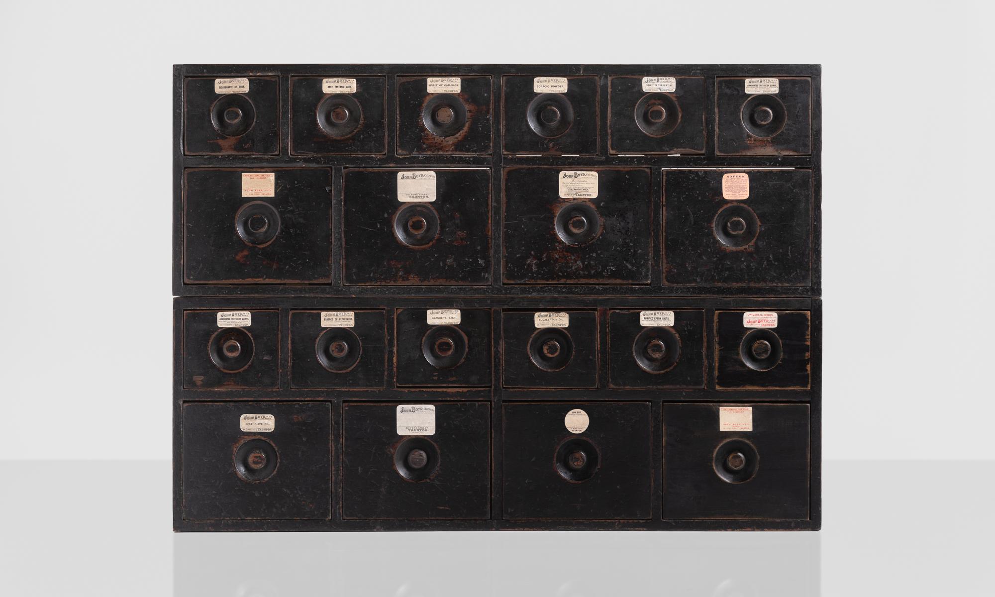 Apothecary chest of drawers, England, circa 1875.

Two-part form includes original labels, flush pulls and an amazing patina.