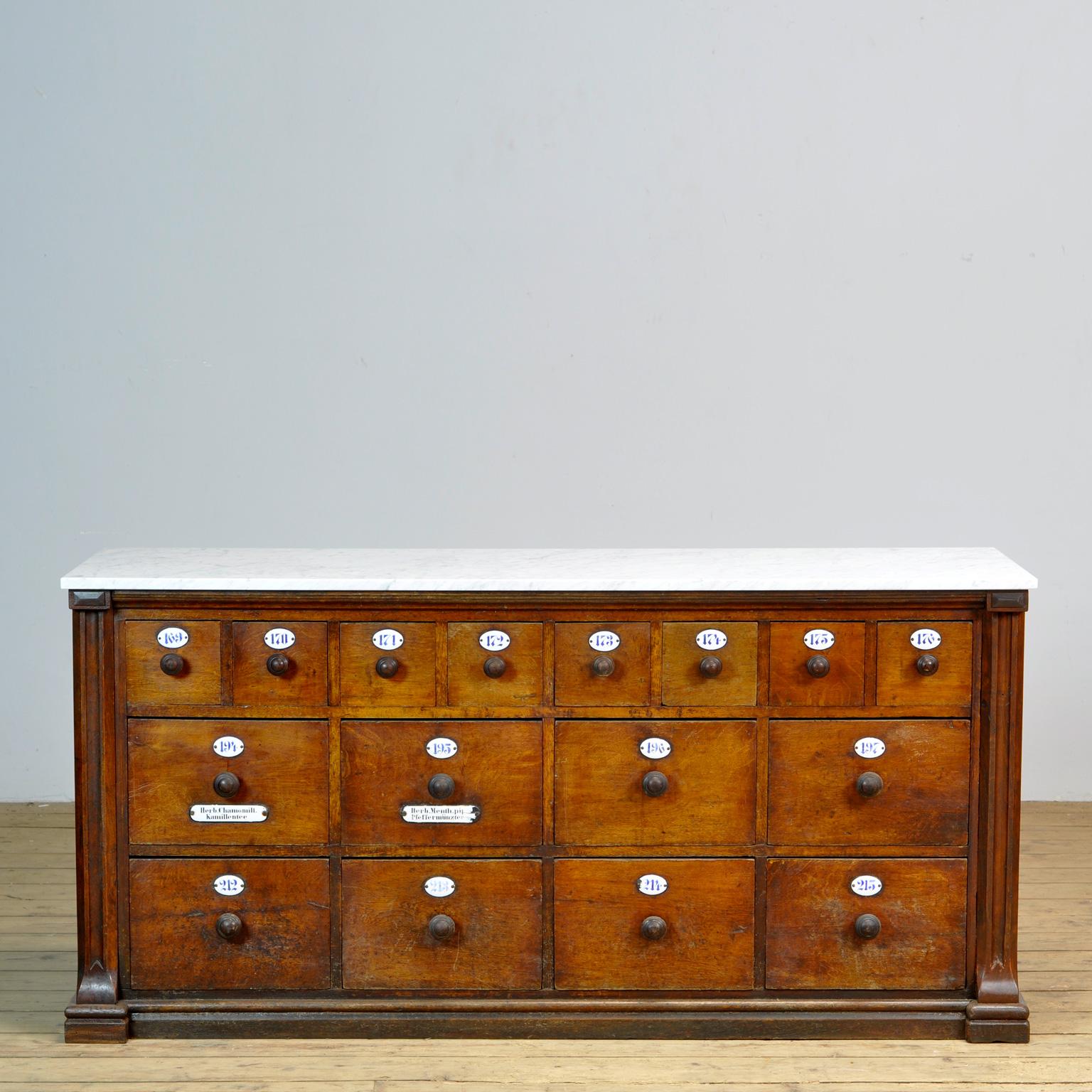 Apothecary's chest of drawers from the 1930s. The cabinet comes from a pharmacy in the German city of Lippstadt. The cabinet is made of oak and pine with a new 2 cm thick white marble Carrara top. Beautiful patina on the woodwork. With the original