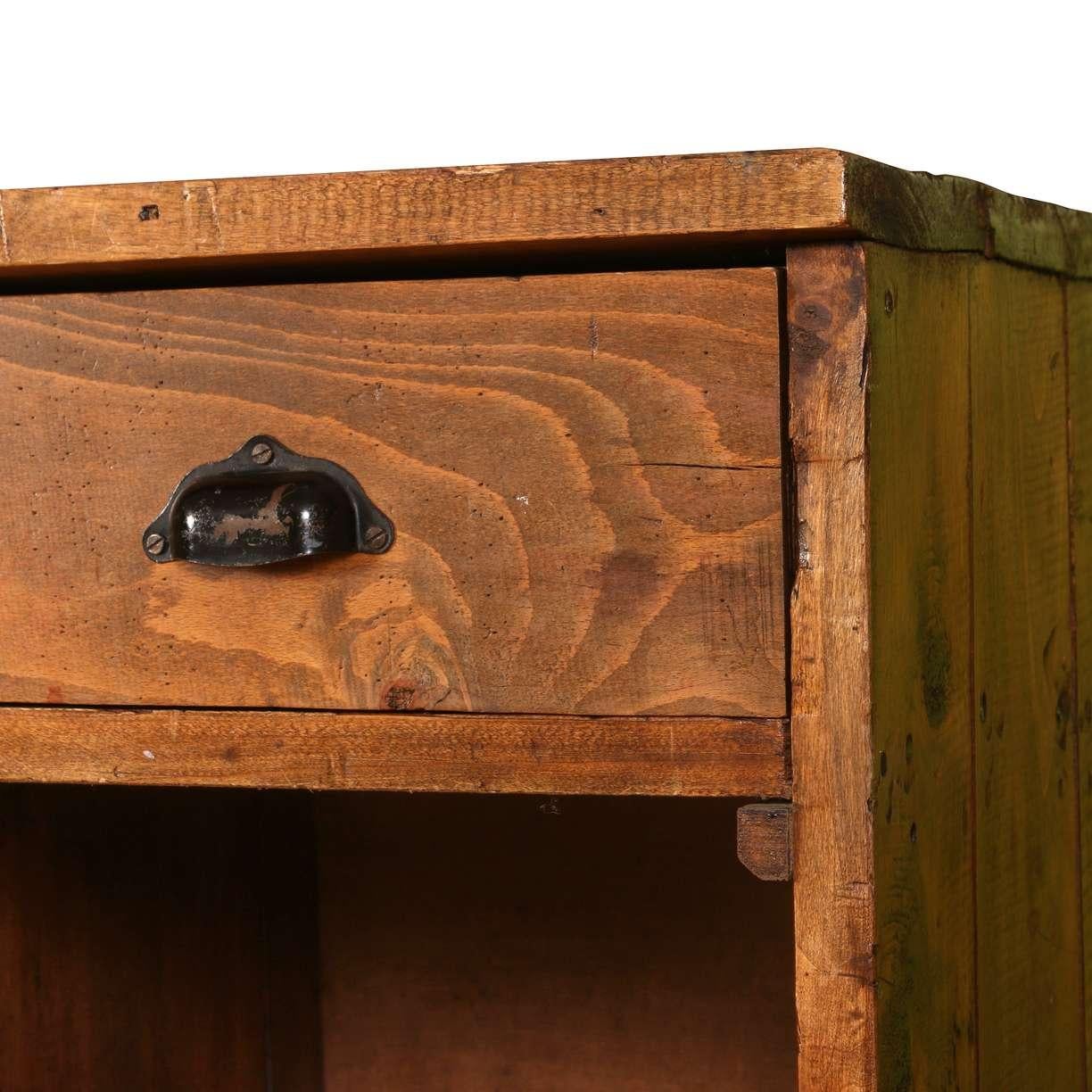 A handsome antique general store counter featuring five small drawers above open cubby compartments. Crafted from solid wood with a warm, worn patina. The black metal drawer pulls and sturdy construction speak to its practical, utilitarian roots.