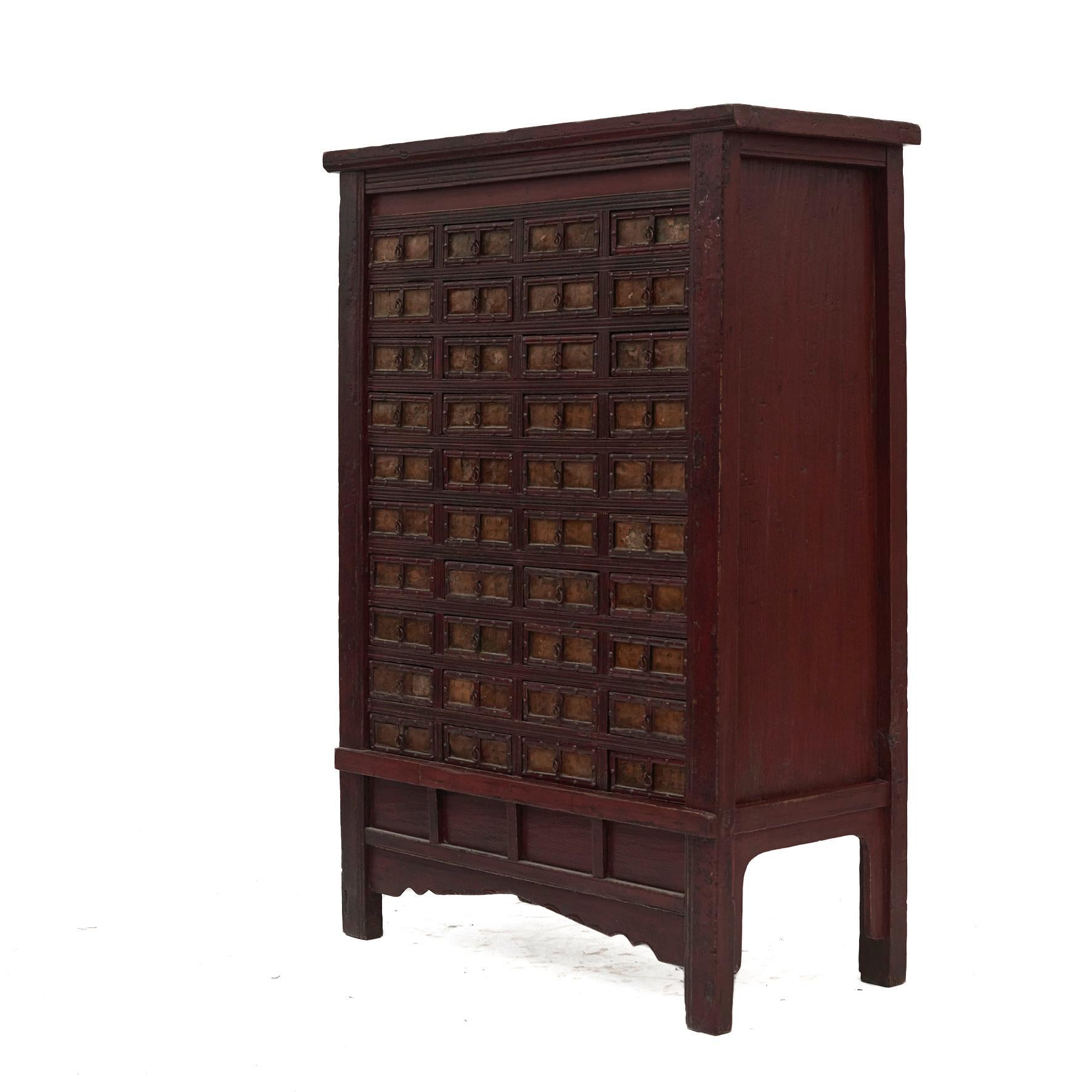 Medicine chest in original red lacquer with 40 drawers. with Chinese calligraphy in lacquer. 
These were used to store and organise Chinese herbs and the drawers were labeled according to the herbs that were stored inside.
Previously in China, the