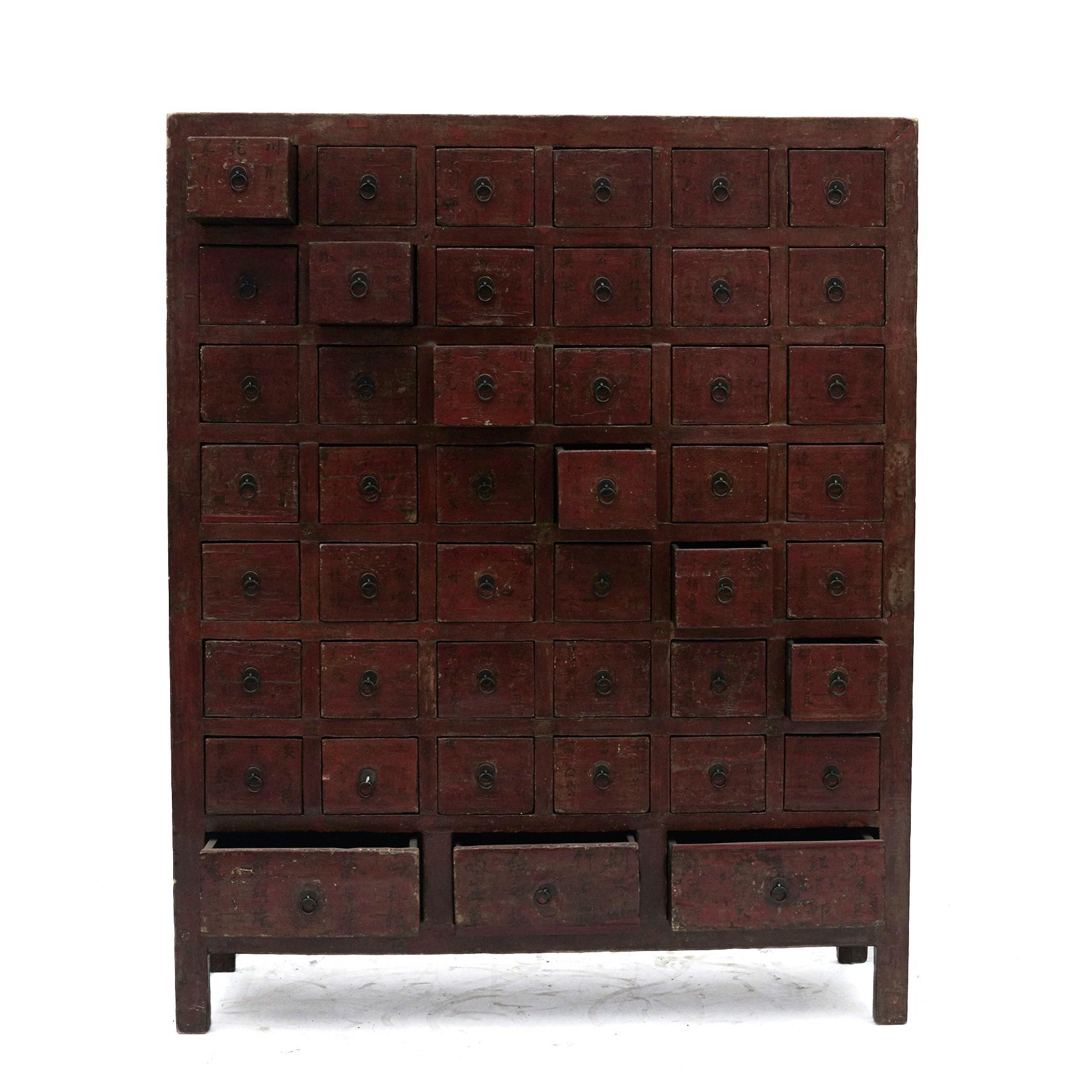 A Chinese Qing Dynasty apothecary / pharmacy medicine chest.
Front in original red lacquer with 45 drawers (42 small drawers + 3 larger drawers at the bottom). 
ach drawer with hand written Chinese calligraphy in black lacquer.
These were used to