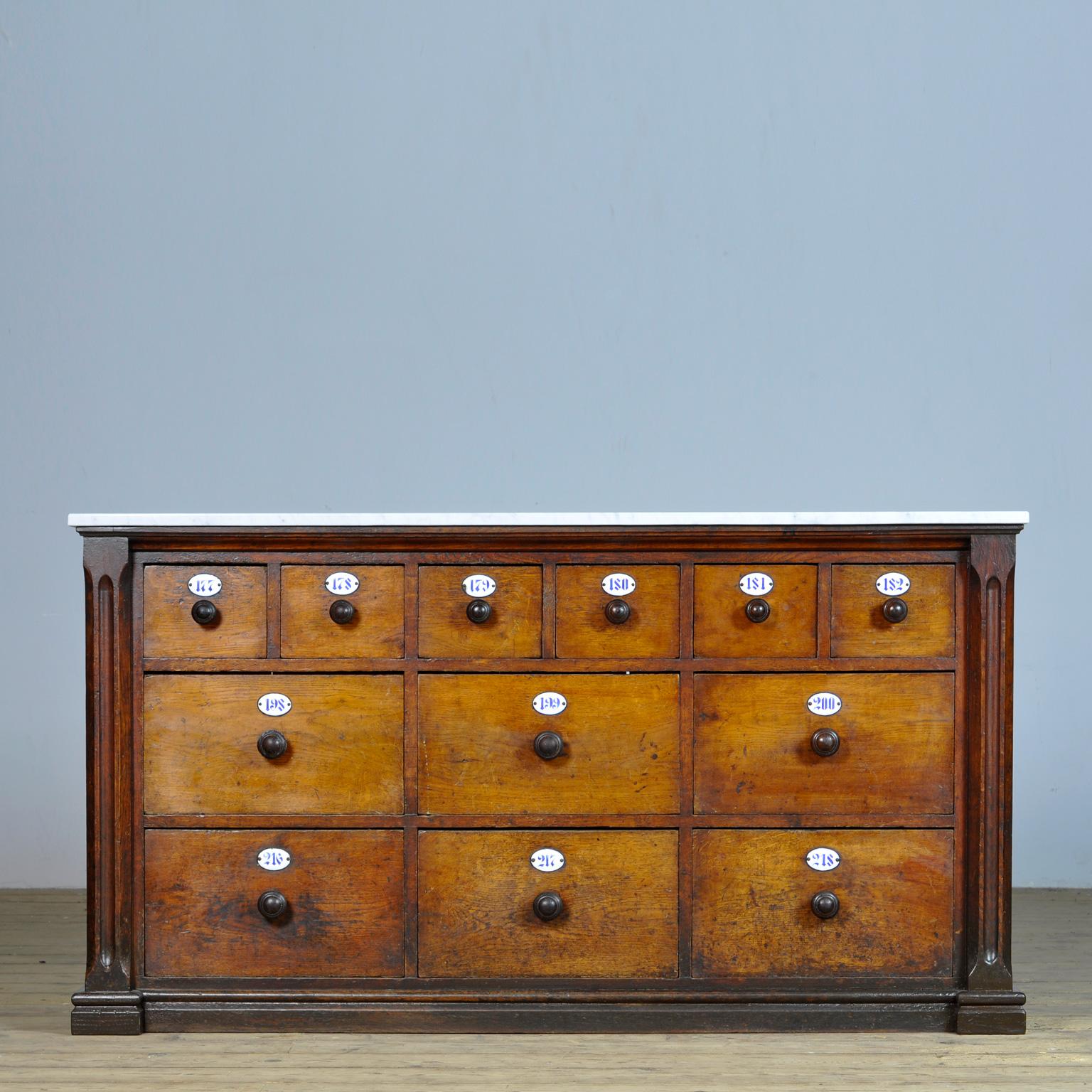 Apothecary's chest of drawers from the 1930s. The cabinet comes from a pharmacy in the German city of Lippstadt. The cabinet is made of oak and pine with a new 2 cm thick white marble top. Beautiful patina on the woodwork. With the original wooden