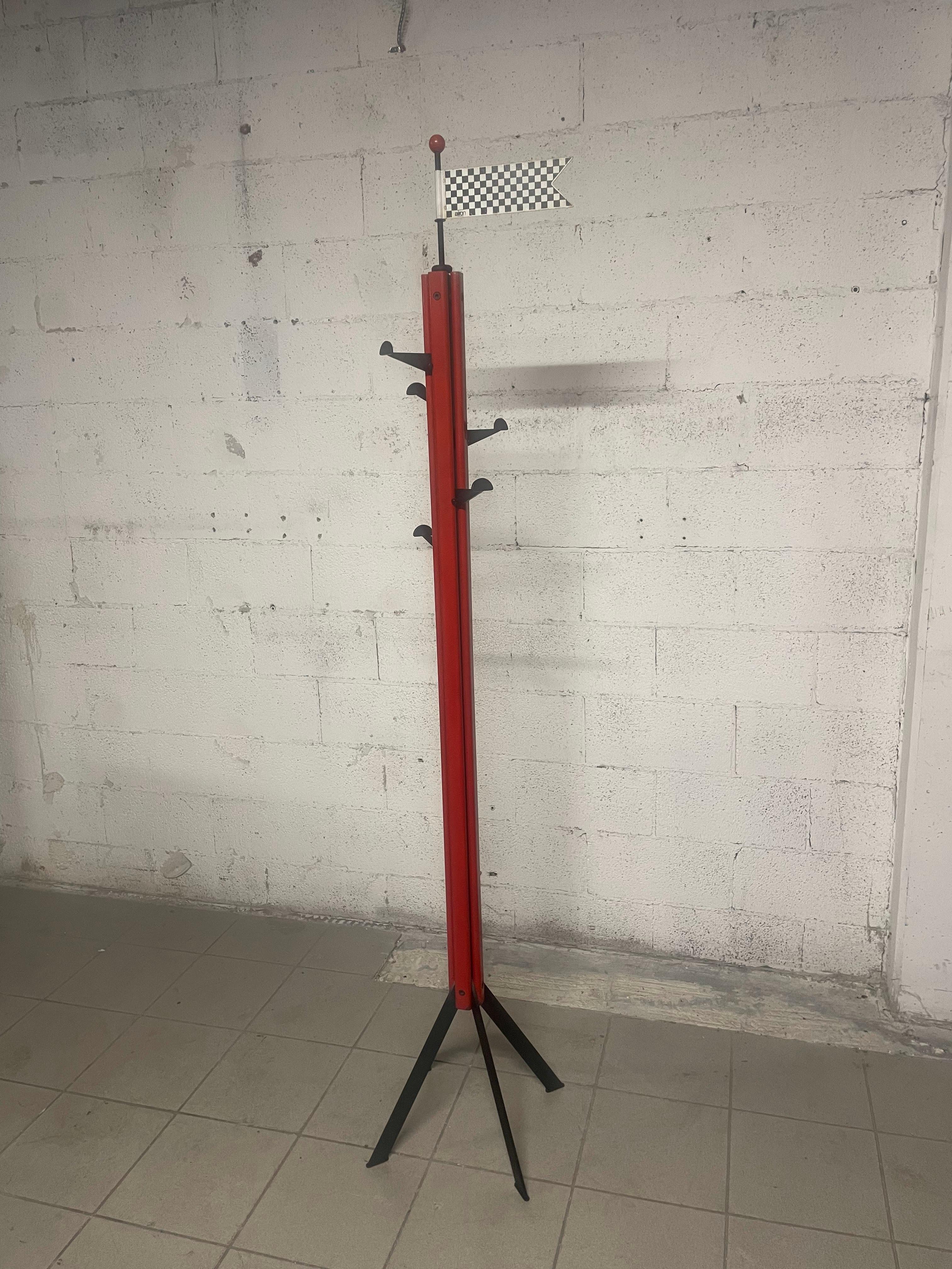 1980s coat stand produced by Airon Milano.
Red and black lacquered metal frame. 
Adjustable height coat hooks and flag marker mounted at apex.
Good vintage condition.