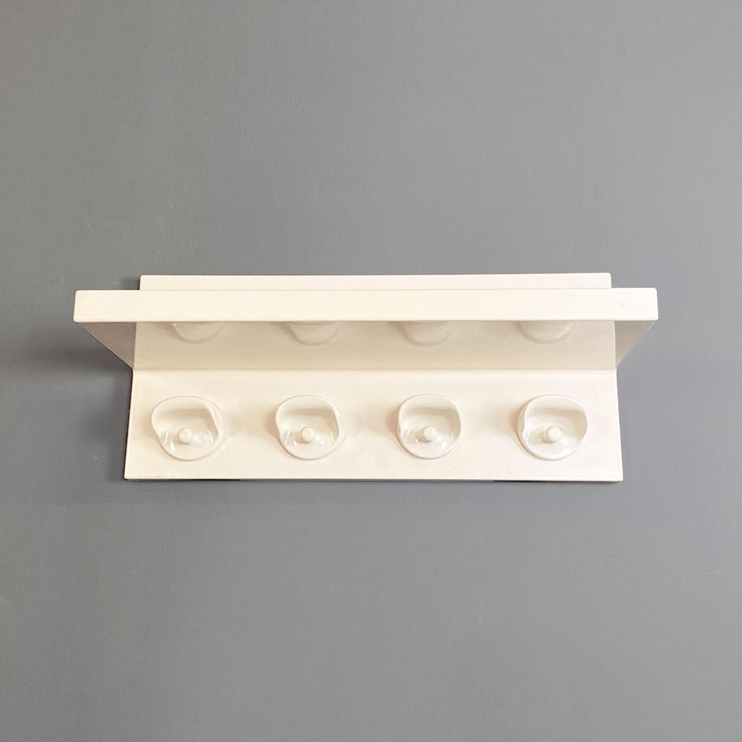 Wall-mounted coat rack Hook model with all-plastic frame in beige color with four hangers and hat rack.
This project combines the design of Olaf Von Bohr's coat rack with that of Marcello Siard's simple shelf, it is in fact a combination of their