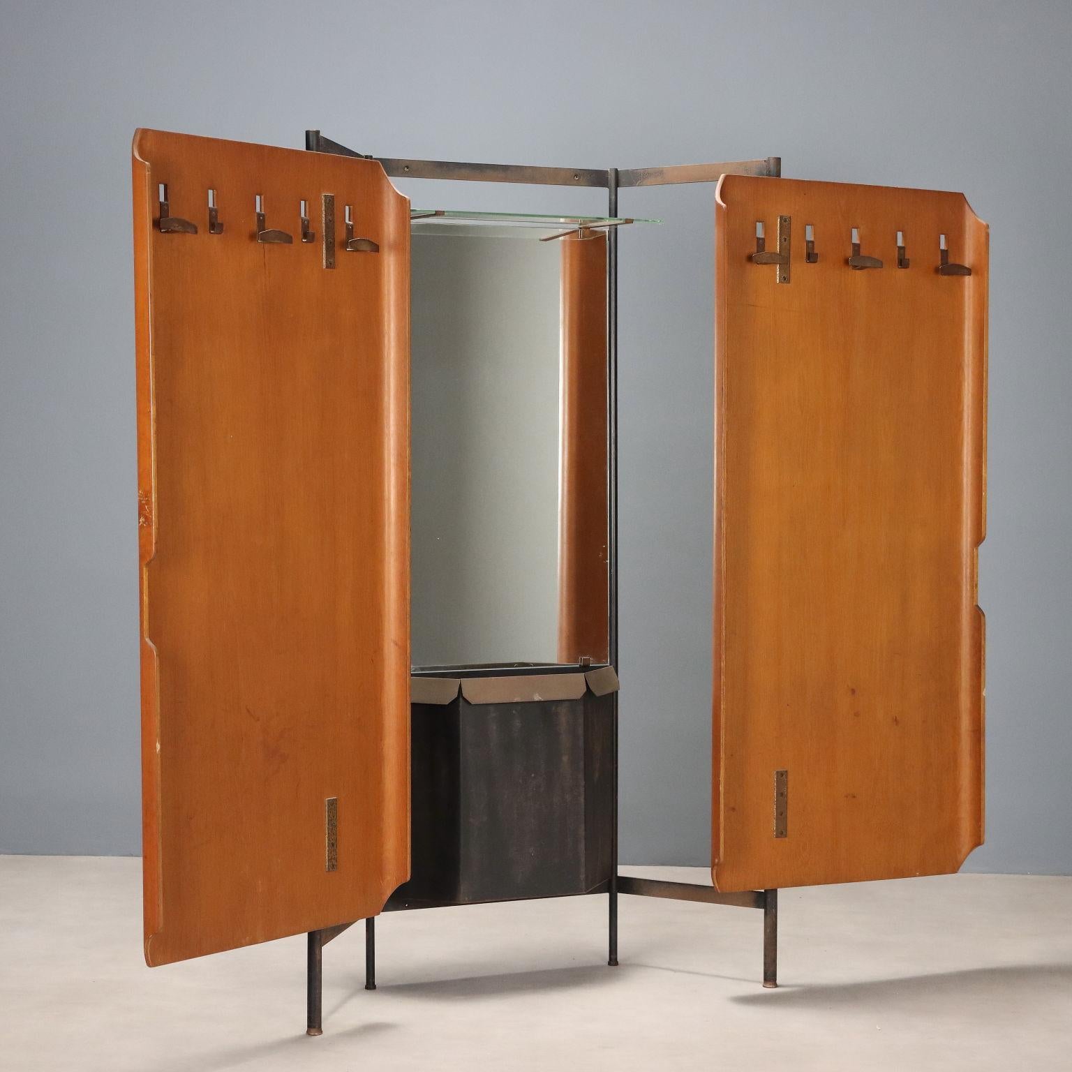 Vintage coat rack with teak veneer plywood doors concealing a mirror, shelf, storage and brass hangers.