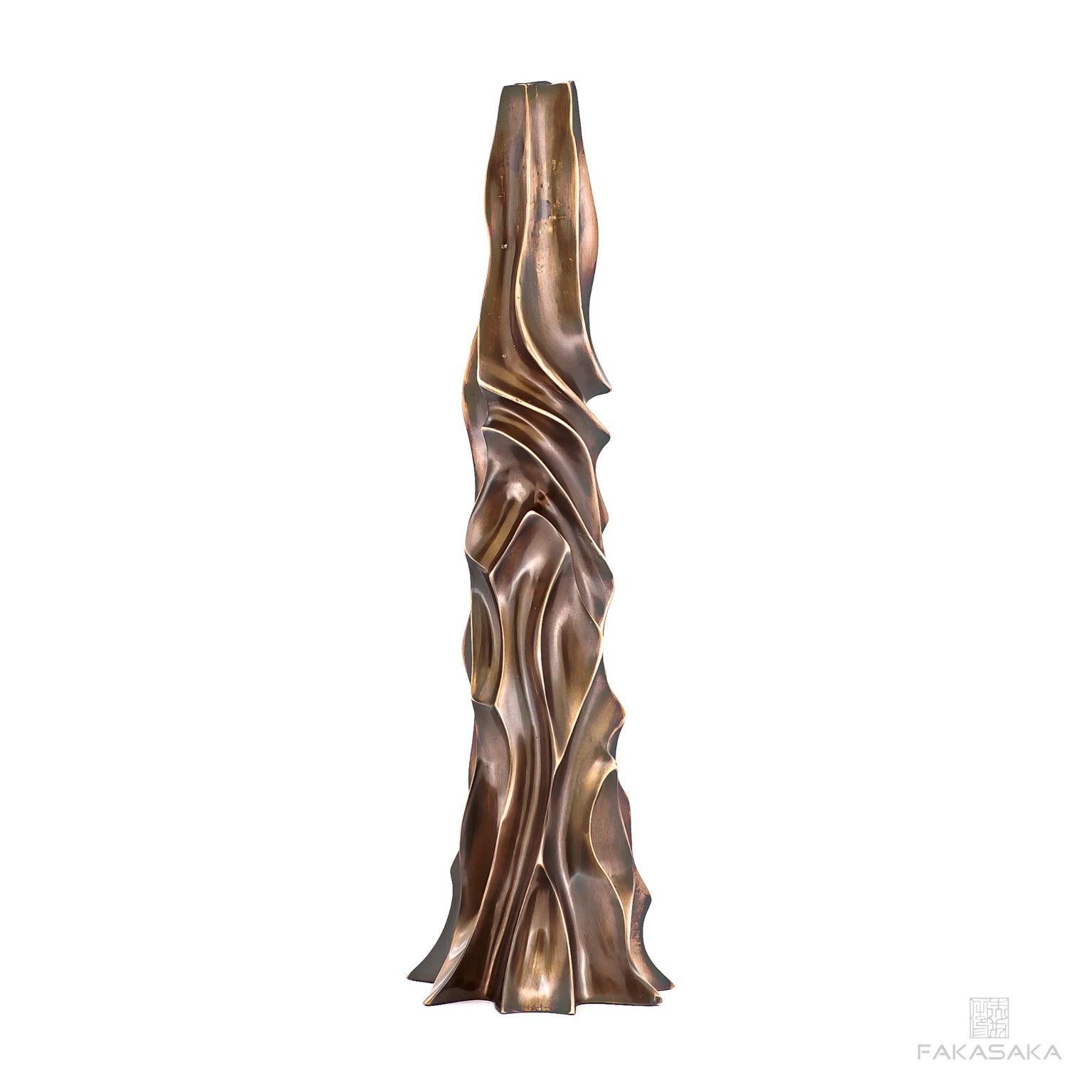 Apple candleholder by Fakasaka design
Dimensions: W 13.5 cm D 13.5 cm H 41.5.
Materials: dark bronze.
Also available in polished bronze. 

 Fakasaka is a design company focused on production of high-end furniture, lighting, decorative objects,