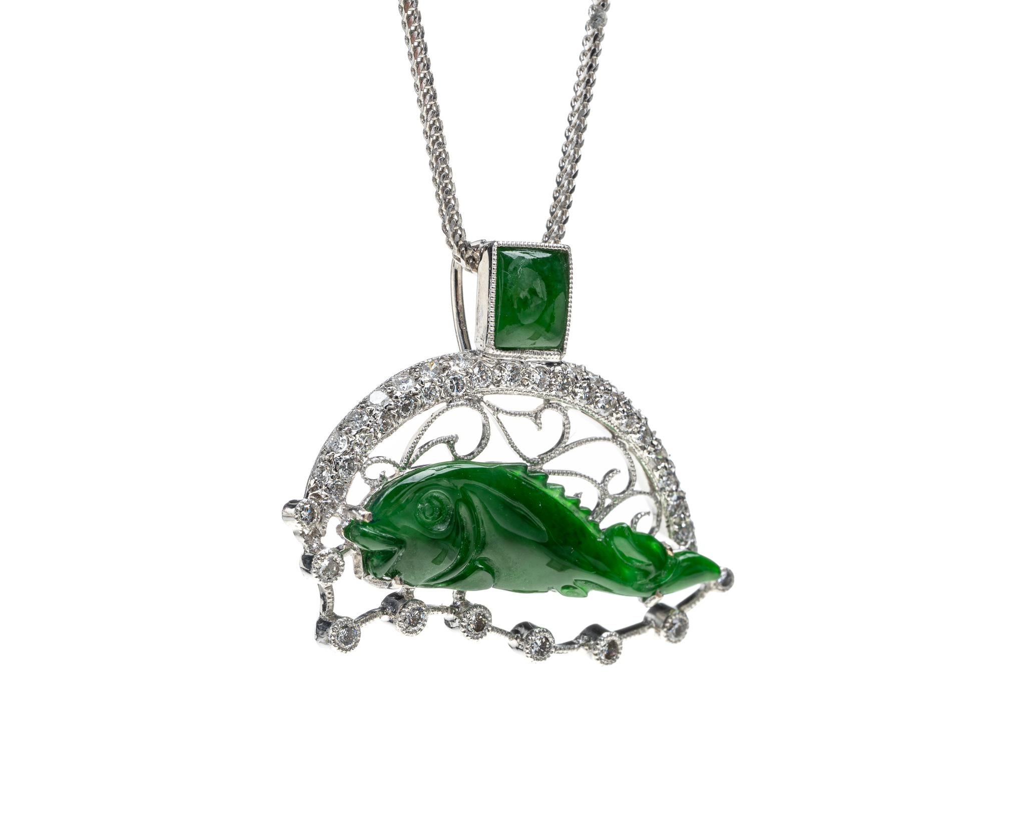This is an all natural, untreated jadeite jade carved fish pendant set on an 18K white gold and diamond bail.  The carved fish symbolizes wealth and prosperity.

It measures 0.90 inches (23 mm) x 1.15 inches (29.3 mm) with thickness of 0.16 inches