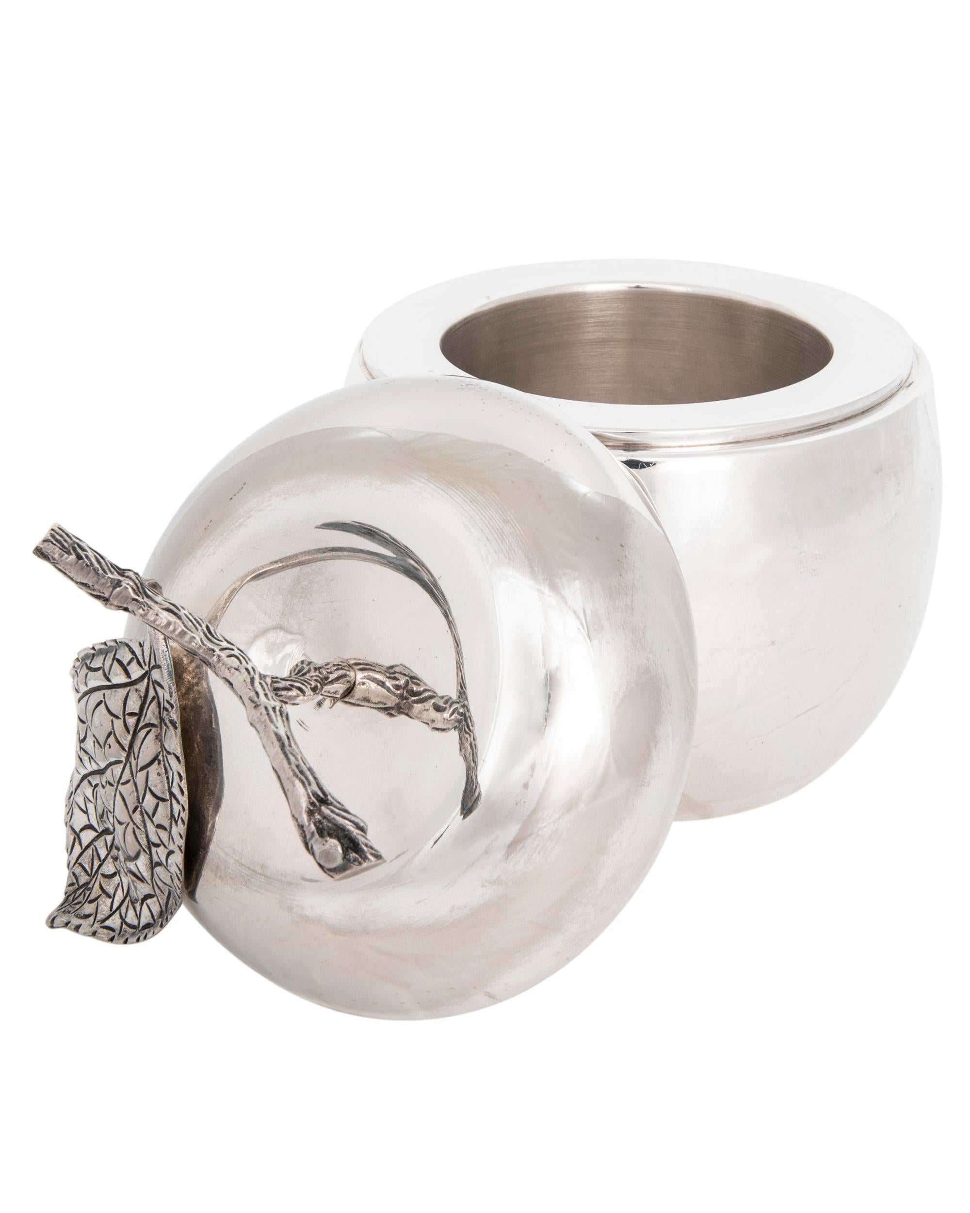 This charming and whimsical silver plated ice bucket is shaped like an apple with a 