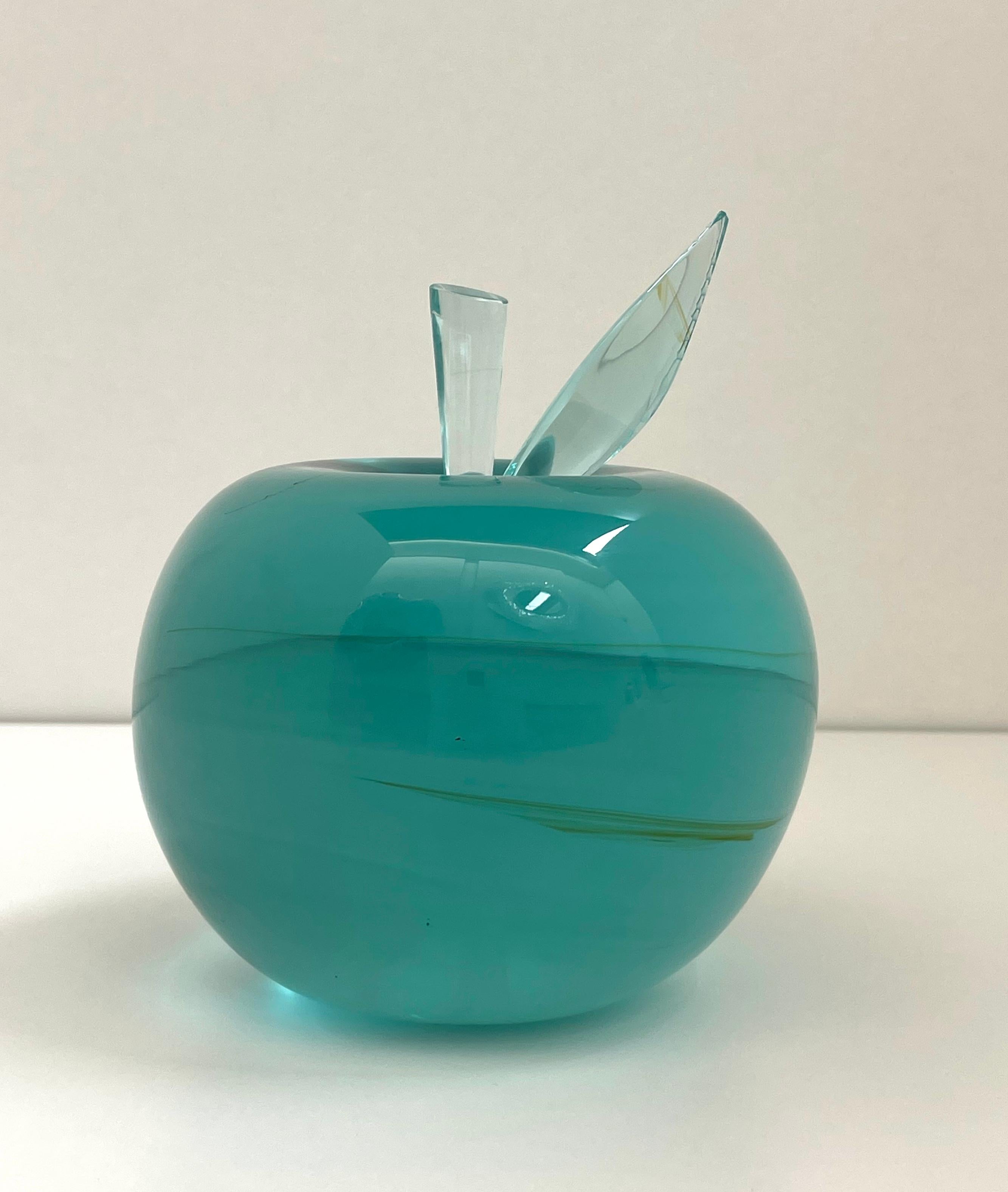 This apple was crafted from a whole natural raw block of aquamarine crystal.
This block was ground and polished for several hours by hand until it obtained the shape of an apple and a very smooth and shiny surface.
The transparency of the crystal