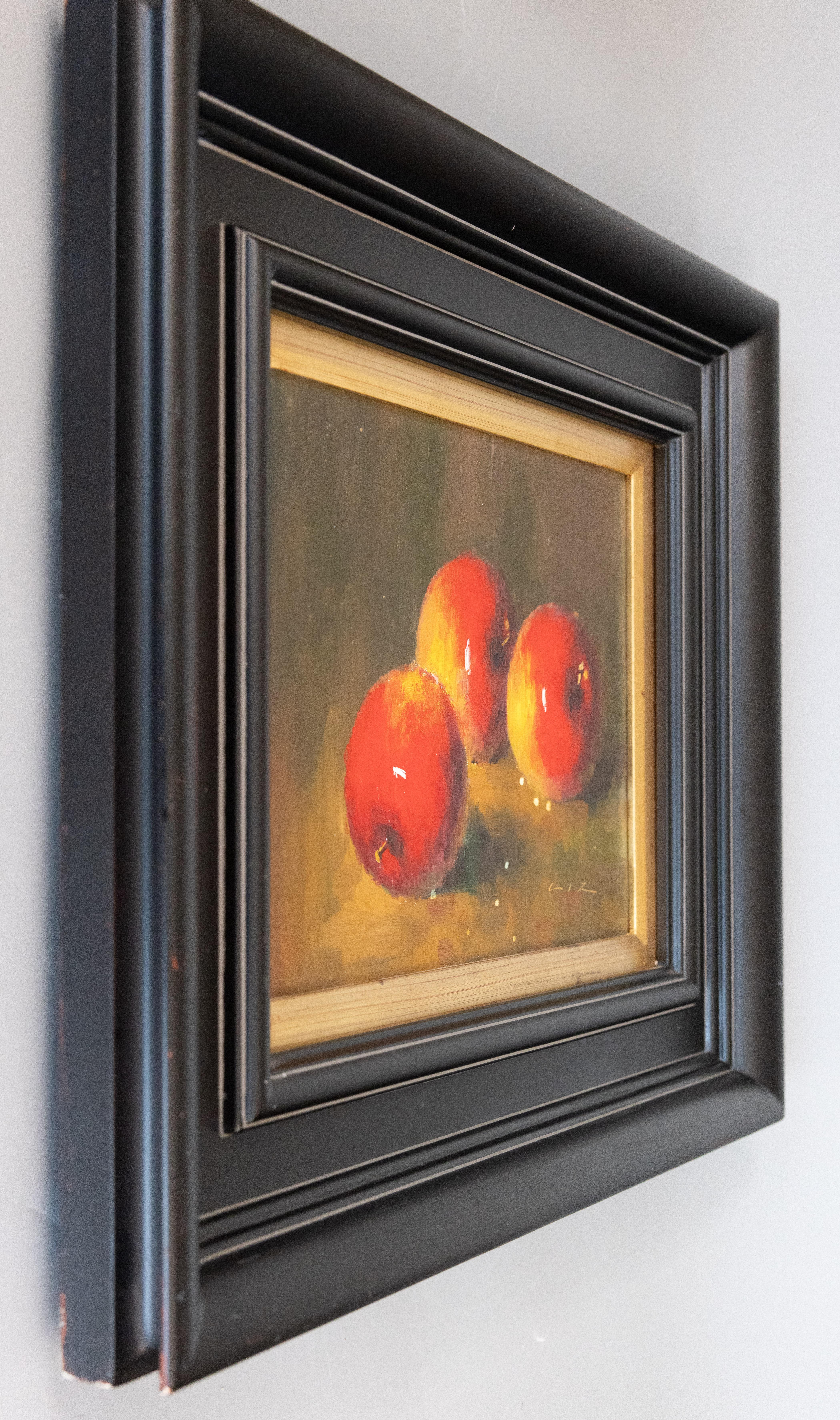 Lovely signed still life oil on canvas featuring three red and golden apples cast in warm light. Signed LIZ. 

Measurements: 26.0