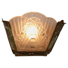 Art Deco wall sconce made of brass and worked glass