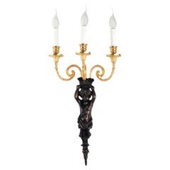 Mytho aplique de tres luces en bronce con putto