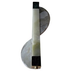 Sinuous wall sconce in onyx, gold calacatta marble, alps green and levanto red 