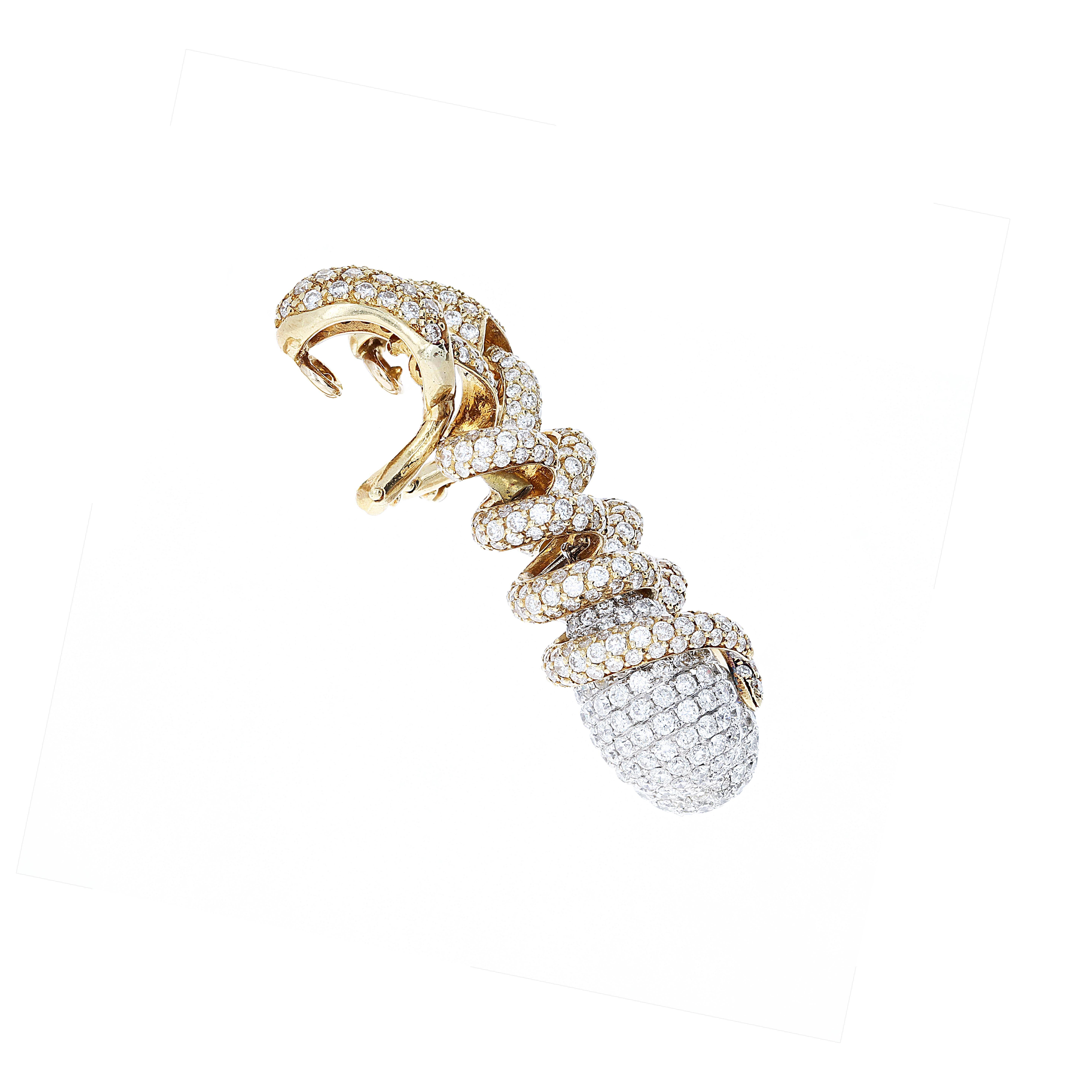 These are such a cool pair of earrings. Approximately 6.50 carats of white diamonds set in both 18kt white and yellow gold. The intertwined looks allow light to shine off all sides of the earrings. Wear them up, or wear them down. The drops move