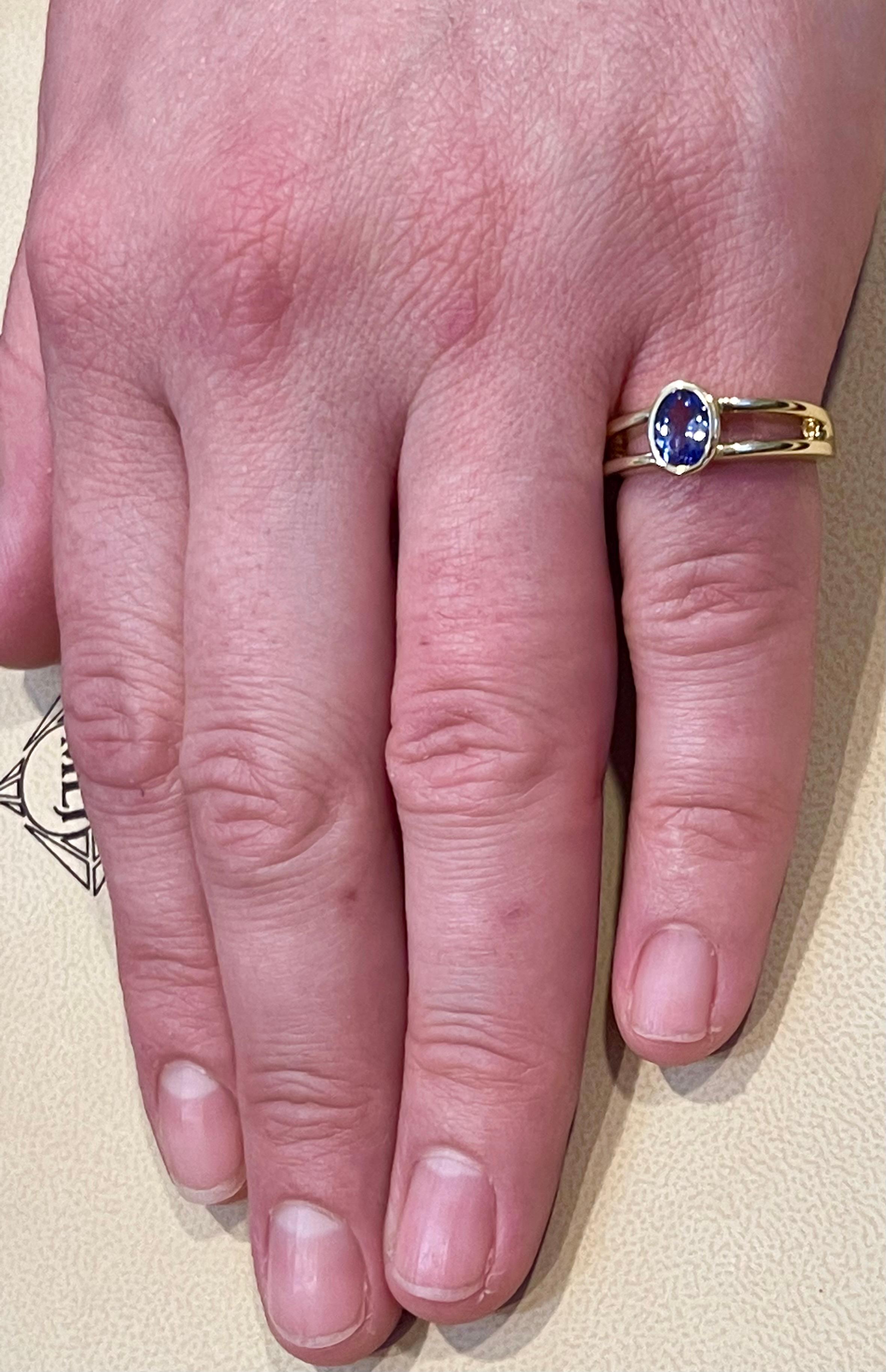 Women's Approximately 0.75 Carat Oval Shape Tanzanite Ring 14 Karat Yellow Gold