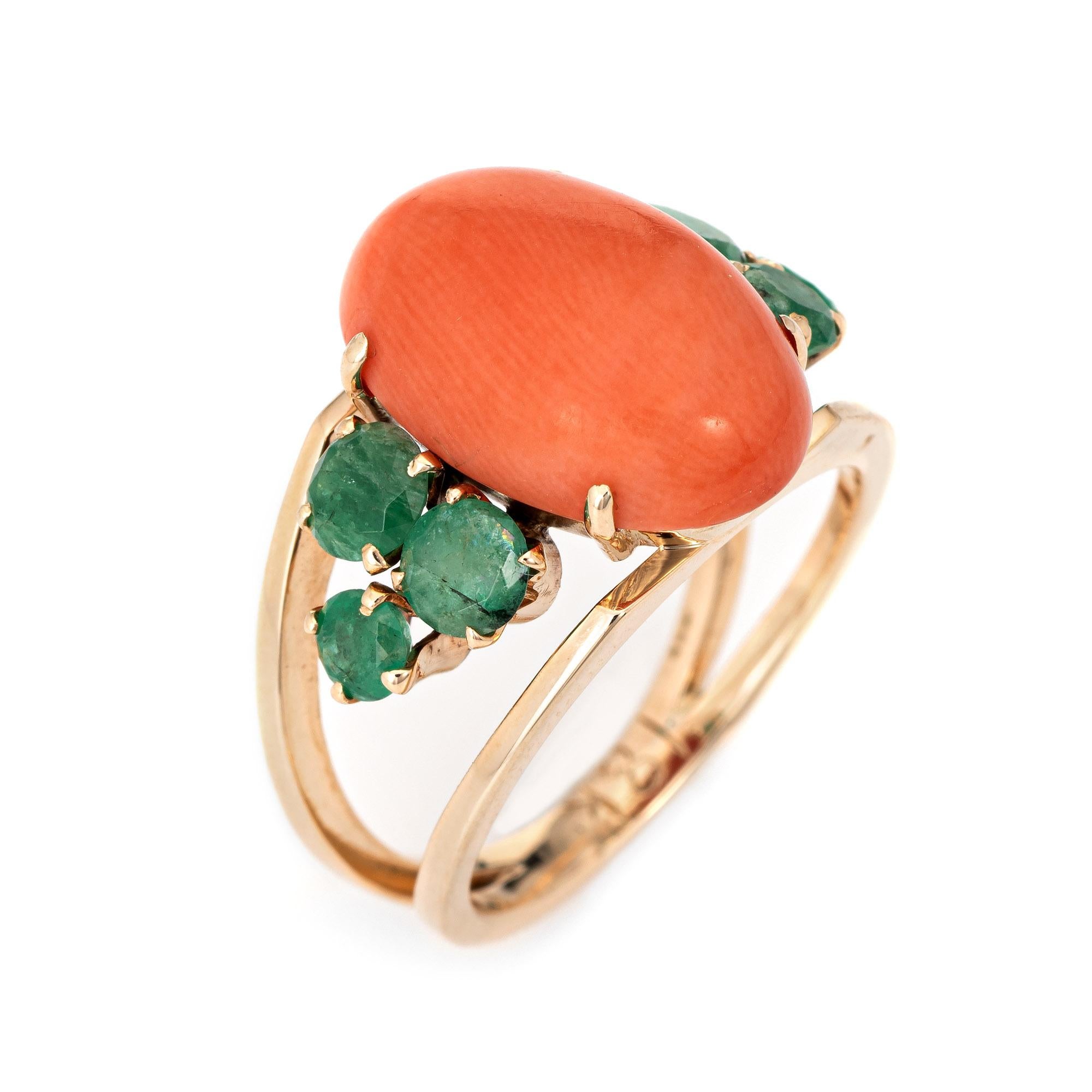 Stylish vintage coral & emerald cocktail ring (circa 1960s to 1970s) crafted in 18 karat yellow gold. 

Coral cabochon measures 15.5mm x 10mm (estimated at 6 carats). The coral is in excellent condition and free of cracks or chips. The emeralds