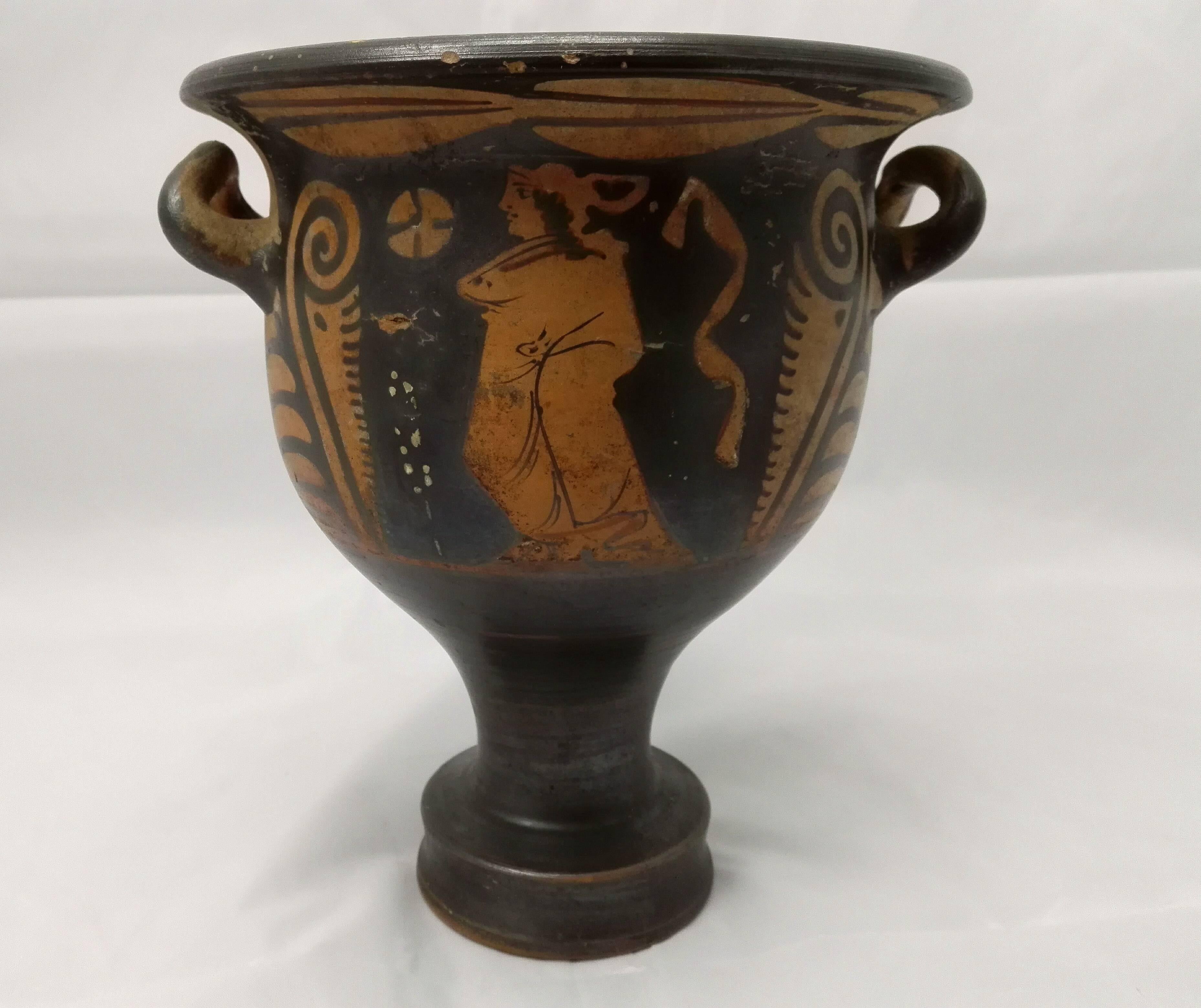 A very nice and important example, red-figure painted, pottery wine bowl. The wonderfully shaped foot carries the bell-shaped cup, which is provided in both sides with beautiful undamaged handles! The figurative painting is gorgeous and precise,