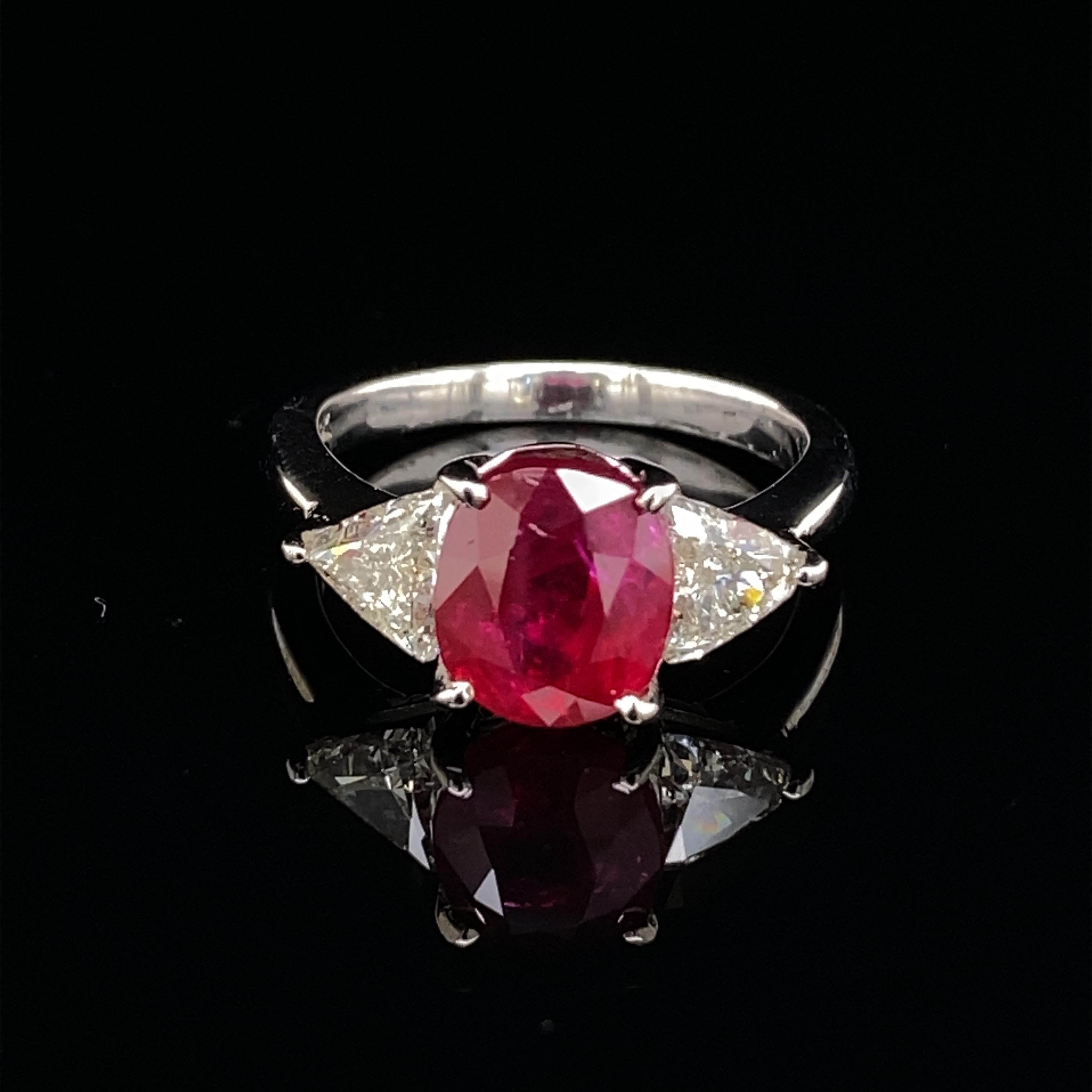 Exceptional Ruby with diamond three stone ring.
Apx 2.30 carat oval ruby complimented with 2 trilliant diamonds, apx 1ct. Approximately H/I color and VS clarity. 3.30ct total gemstone weight, in 18k white gold. 
Accommodated with an up to date