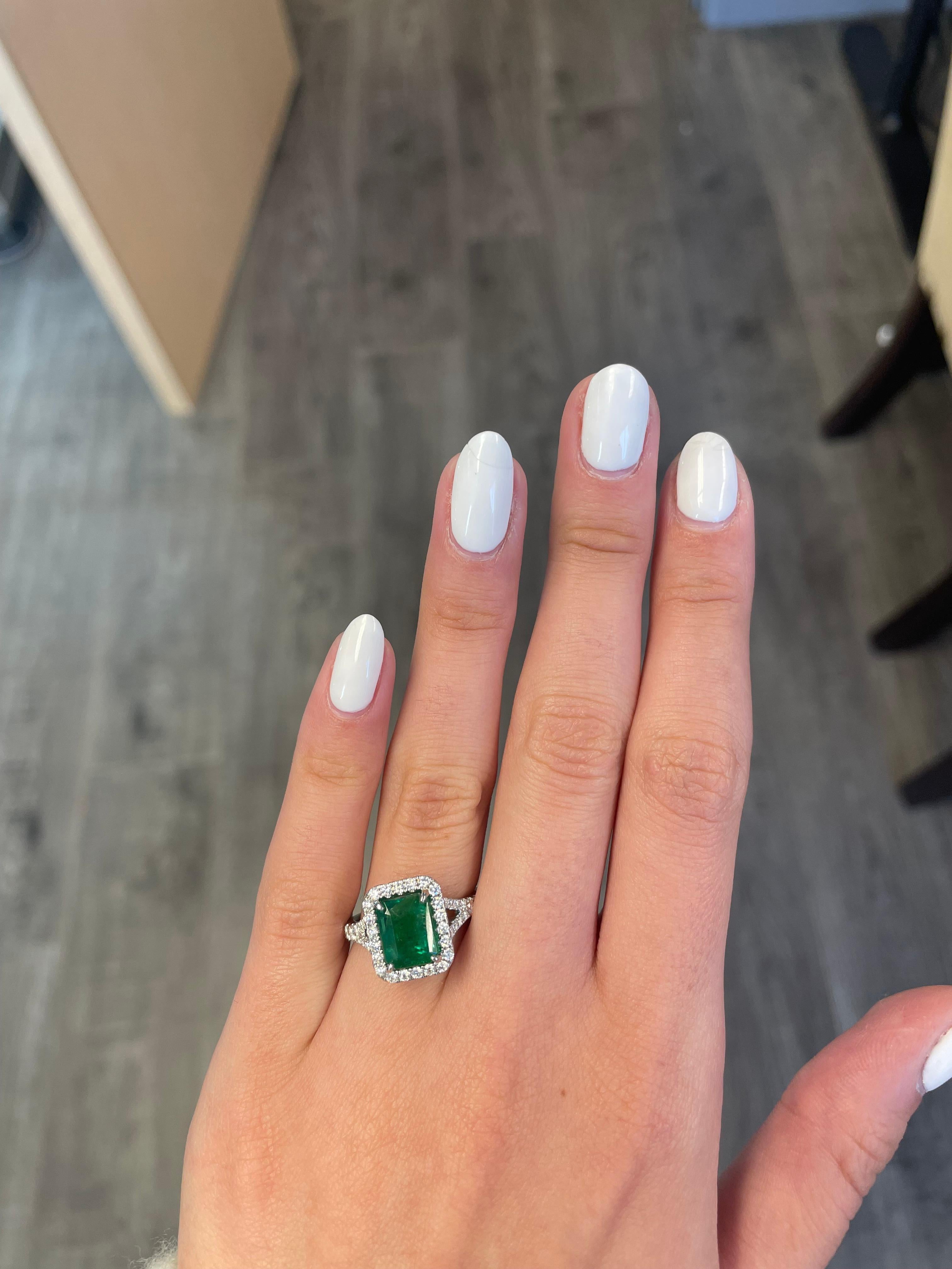 Stunning modern emerald and diamond halo ring with split shank.
Approximately 3.30 carats total gemstone weight.
Approximately 2.50 carat emerald cut emerald, F2. Complimented by 54 round brilliant diamonds, approximately 0.80 carats, G/H color and
